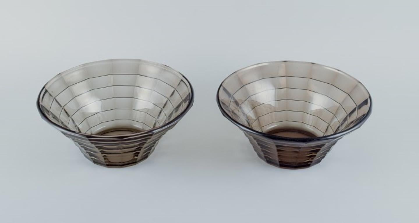 Simon Gate (1883-1945) for Orrefors/Sandvik, Sweden.
Two large Art Deco bowls in smoked-coloured pressed glass.
Model G756.
Circa 1940.
In perfect condition.
Dimensions: Diameter 23.5 cm x Height 10.0 cm.
