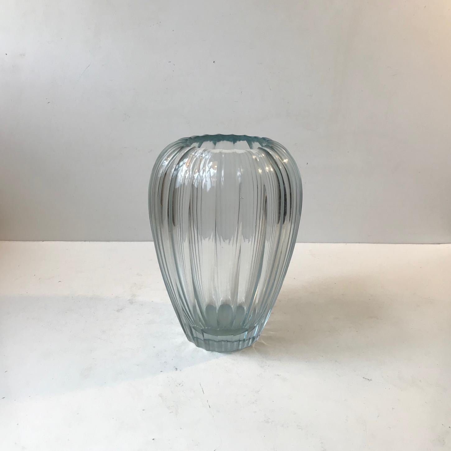 Important piece of Swedish art glass history. A Triton vase in vaguely blue tinted clear, multi-faceted, beveled and polished crystal glass. Designed in 1916 by Sculptor Simon Gate (1893-1945) and examples of this design was executed at Orrefors