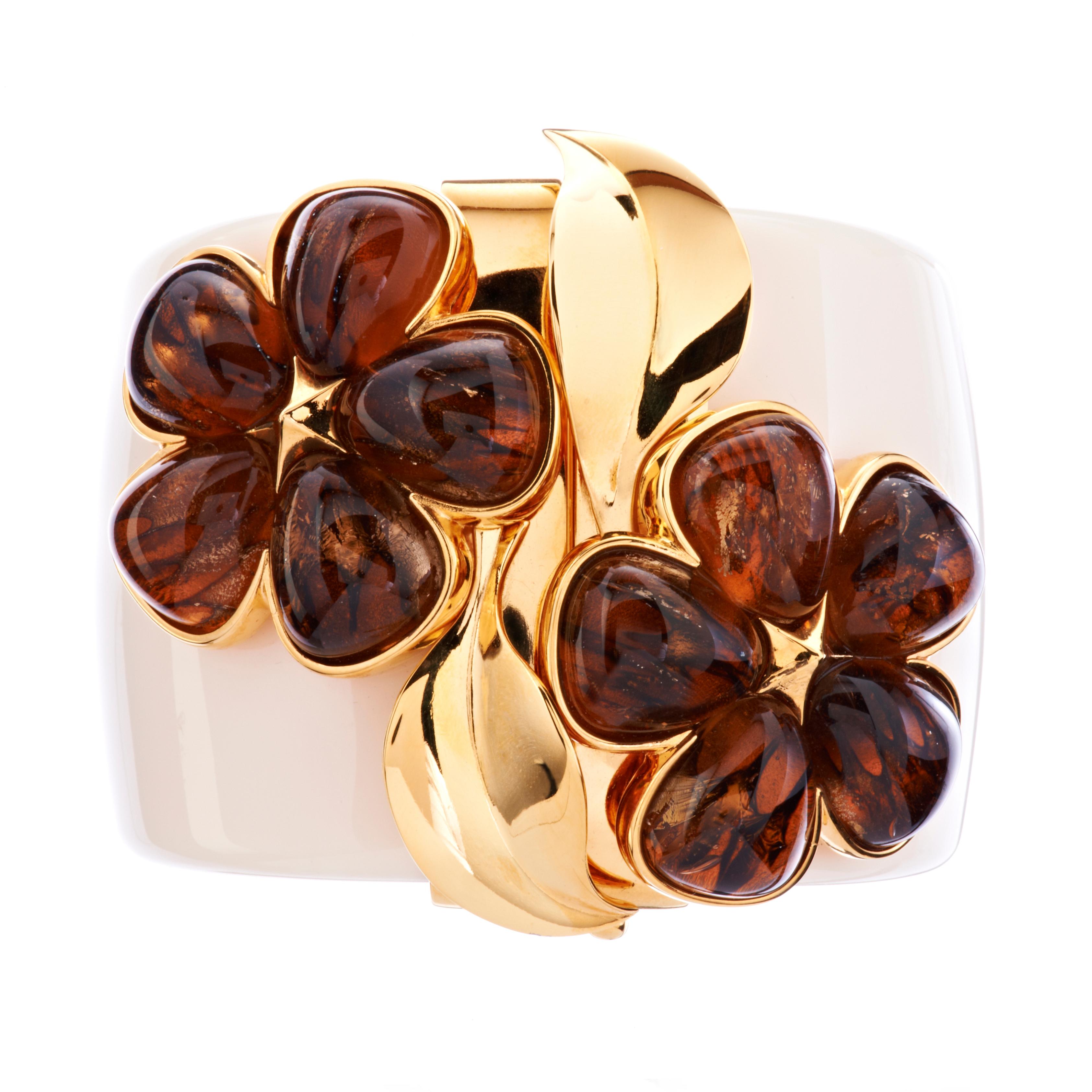 The Chloris bangle is set with delicately decorated glass petals with gold leaf inclusions. These are individually hand made by highly skilled artisans in Germany using an age old secret method.

This bangle comes in S/M and M/L sizes, and in black.
