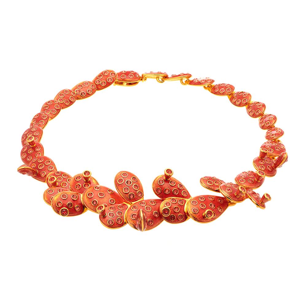 Drawing inspiration from the iconic Mexican artist Frida Kahlo, this collection embodies her distinctive style and creative nature. Overlapping rounded Opuntia branches are hand enamelled in a glossy bold Padparadscha, set on Gold plating to bring