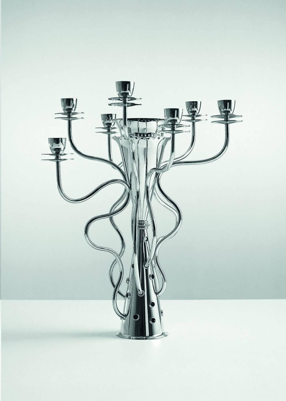 The seven branches of the candleholder by Borek Sipek design are pushing up with sinuous curves, as if they were shoots of a wild plant.

Borek Sipek (1949-2016) studied interior design at the school for Arts and Crafts in Prague from 1964-1968. He