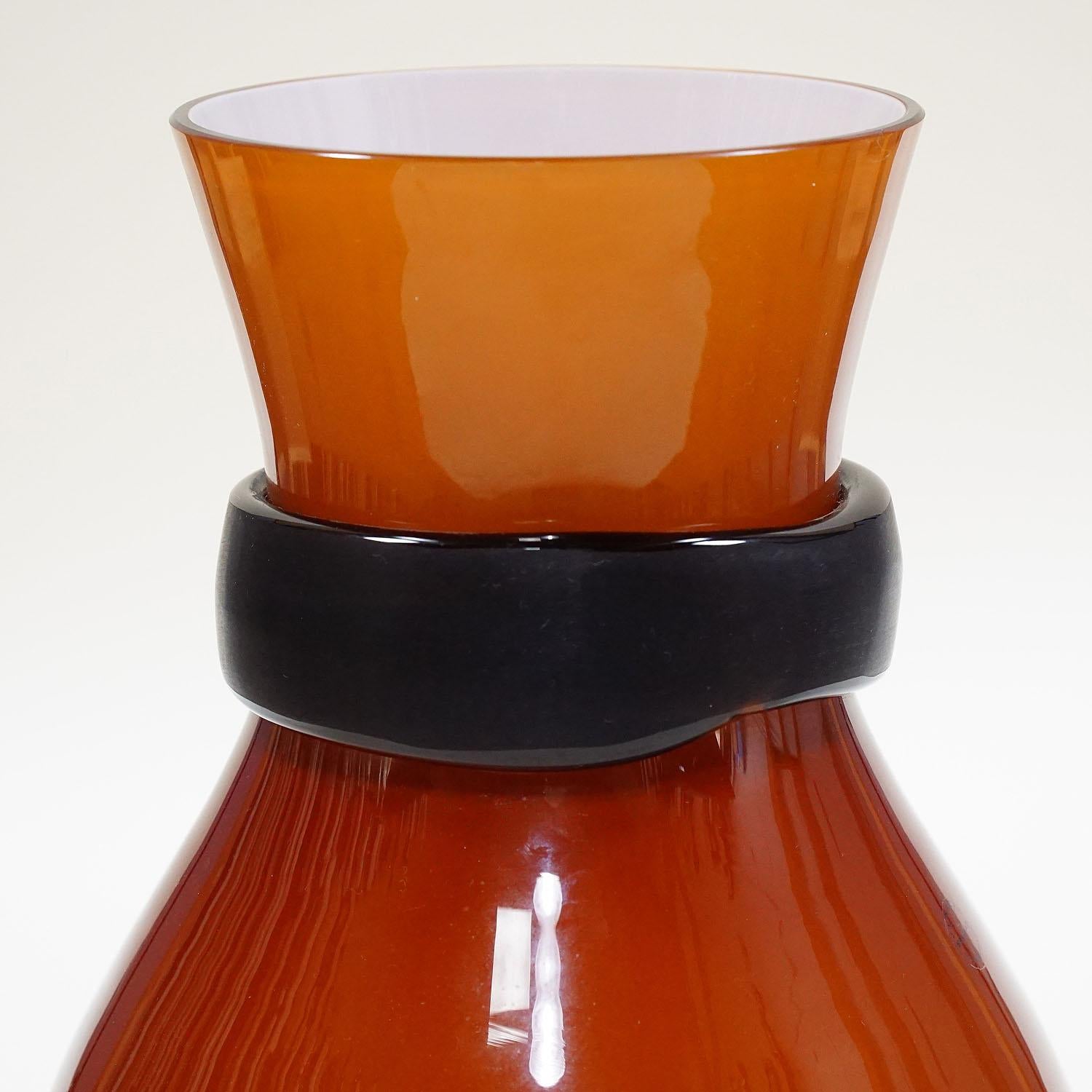 A large art glass vase designed by Simon Moore and manufactured by Salviati, Venice in 2004. Opaque white and brown glass with clear glass surface, grinded black glass collar at the throat. Acid etched 'salviati 2004' on the base and company