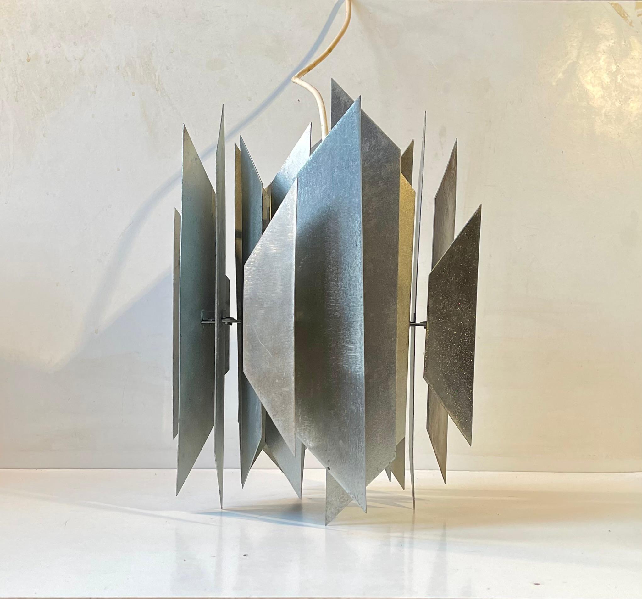 Cette suspension sculpturale de Simon P. Henningsen a été fabriquée par Lyfa et a été conçue à l'origine en 1962 pour le restaurant Divan 2 à Tivoli à Copenhague. Cet exemplaire particulier a été sablé, ce qui lui confère une apparence brutale et
