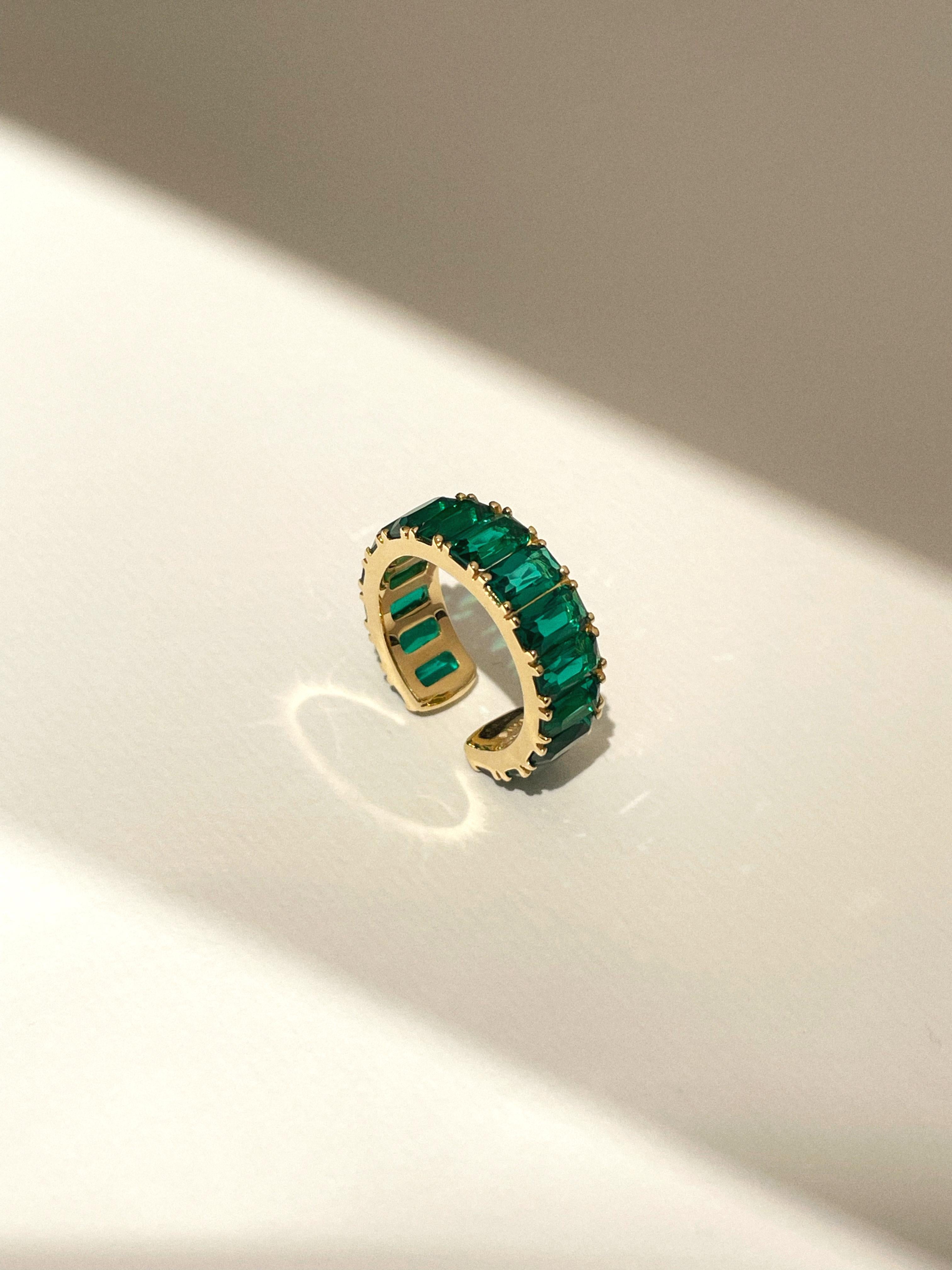 This is one of Nomis bestseller
Multifunctional cuffs that can be worn as earrings and as a ring
18k yellow gold phalanx ring/ ear cuff with baguette lab emeralds 5/3 mm 
stones q-ty: 15
ring' size 13,5