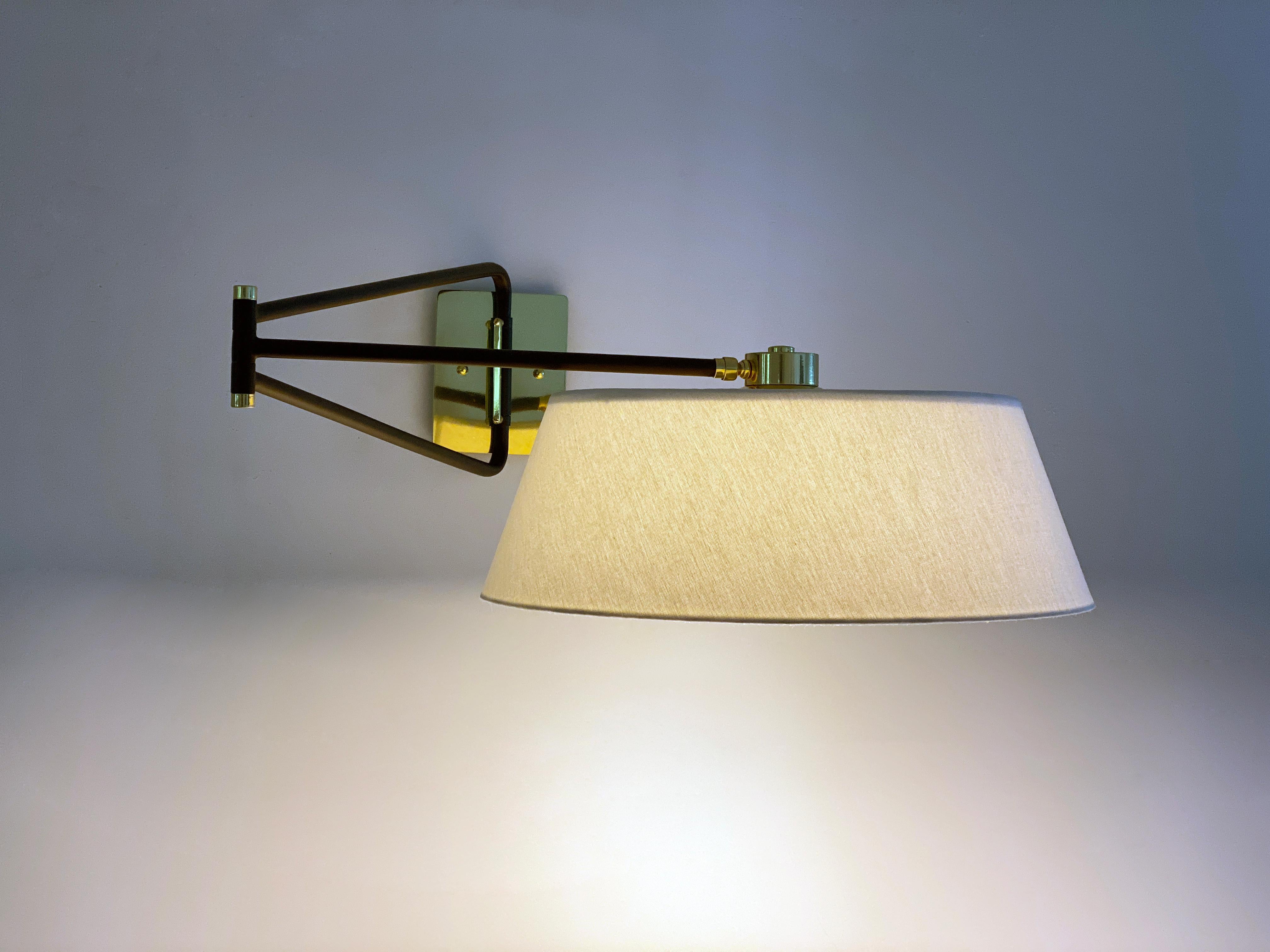 This sleek sconce is 1950s French mid-century by inspiration. Its a companion piece to our Bolivar sconce. The light with its single down shade and articulated arm creates a versatile lighting source. The head pivots to direct the light in various