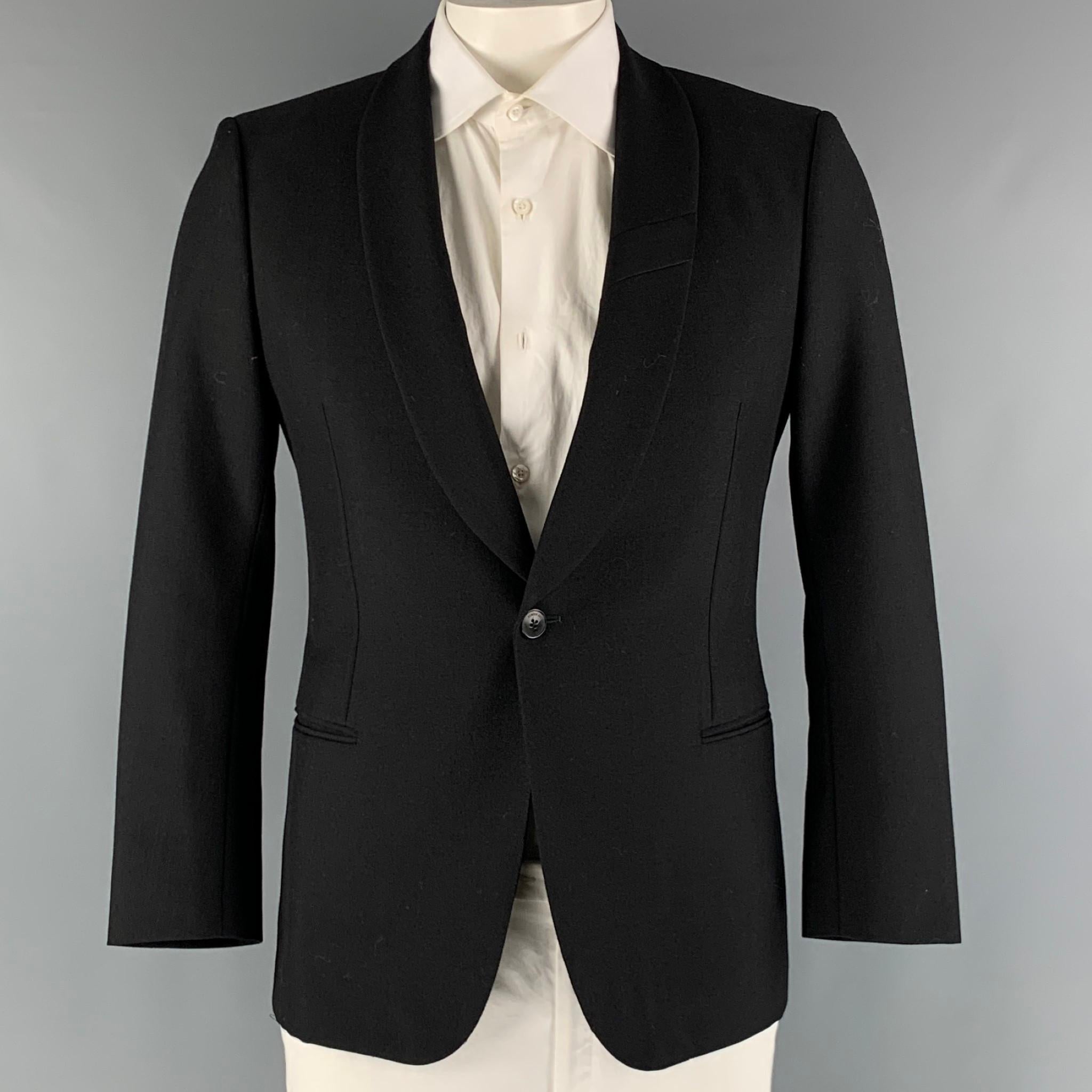 SIMON SPURR sport coat comes in a black wool and mohair woven material featuring a shawl collar, welt pockets, and a single button closure.

Very Good Pre-Owned Condition. AS IS.
Marked: 52

Measurements:

Shoulder: 18 in.
Chest: 40 in.
Sleeve: 24.5
