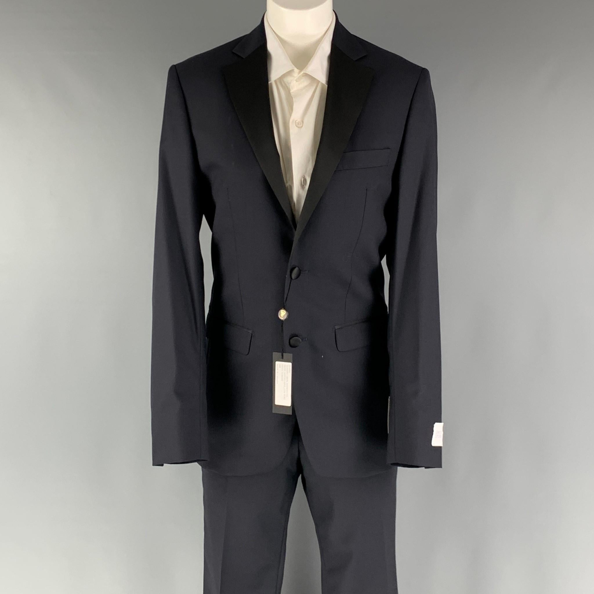 SIMON SPURR 'VALDEX' tuxedo comes in a black woven material with a full liner and includes a single breasted, double button tuxedo style with a notch lapel and matching flat front trousers.

New with Tags.
Marked: 36 R