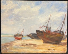 Beached Fishing Boats Resting on the Shoreline under a Cloudy Sky
