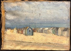 Vintage Coastal Scene with Weathered Beach Huts Along a Sandy Shoreline