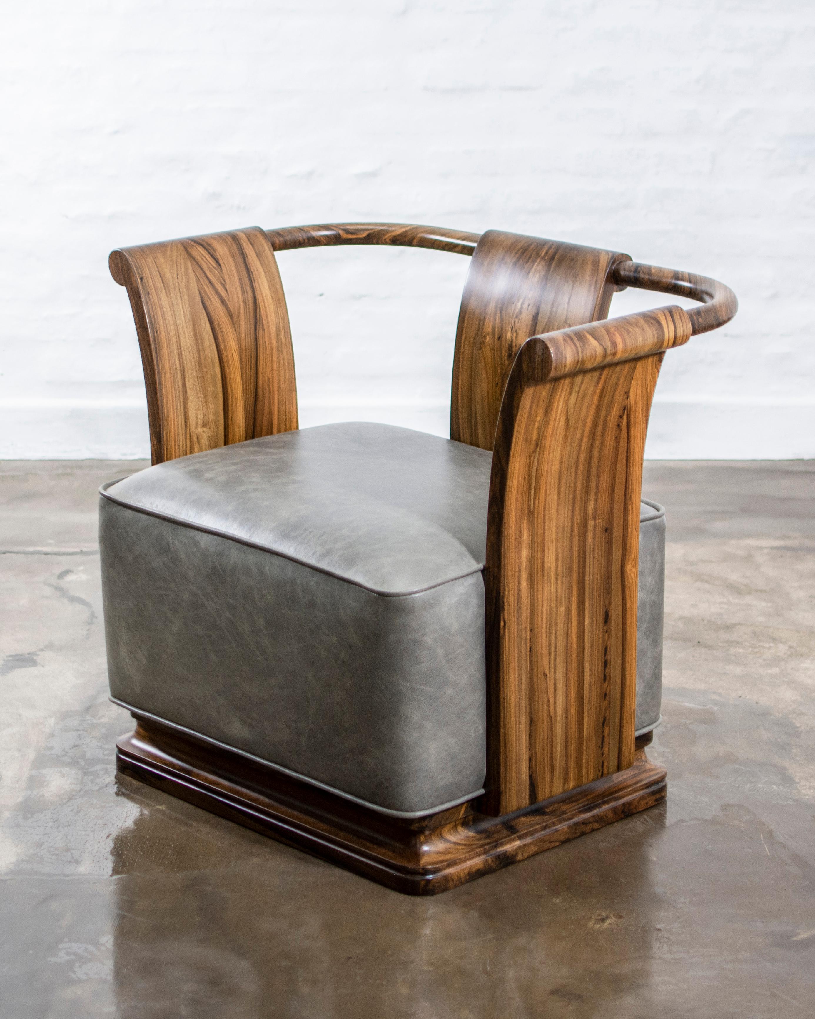 The Simone's gently sloping sides and back allude to forms from early 20th century French design. Debuted in 2009 at the Salone del Mobile. Available immediately as shown in Argentine Rosewood and leather or available in various finishes and the