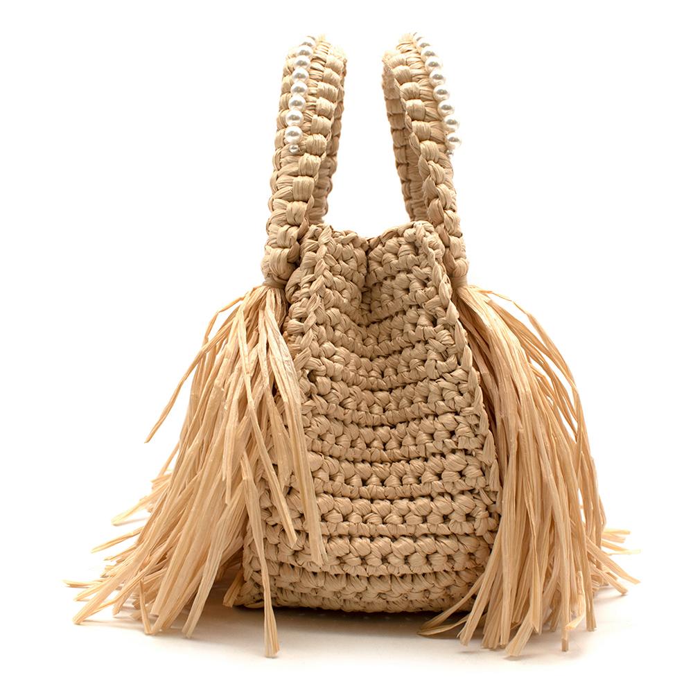 Simone Rocha Runway Faux Pearl Embellished Raffia Tote

Simone Rocha proves that the raffia tote has potential to be carried way beyond the beach with this structured, fringe-trimmed style. The charmingly compact style swings from dual top handles