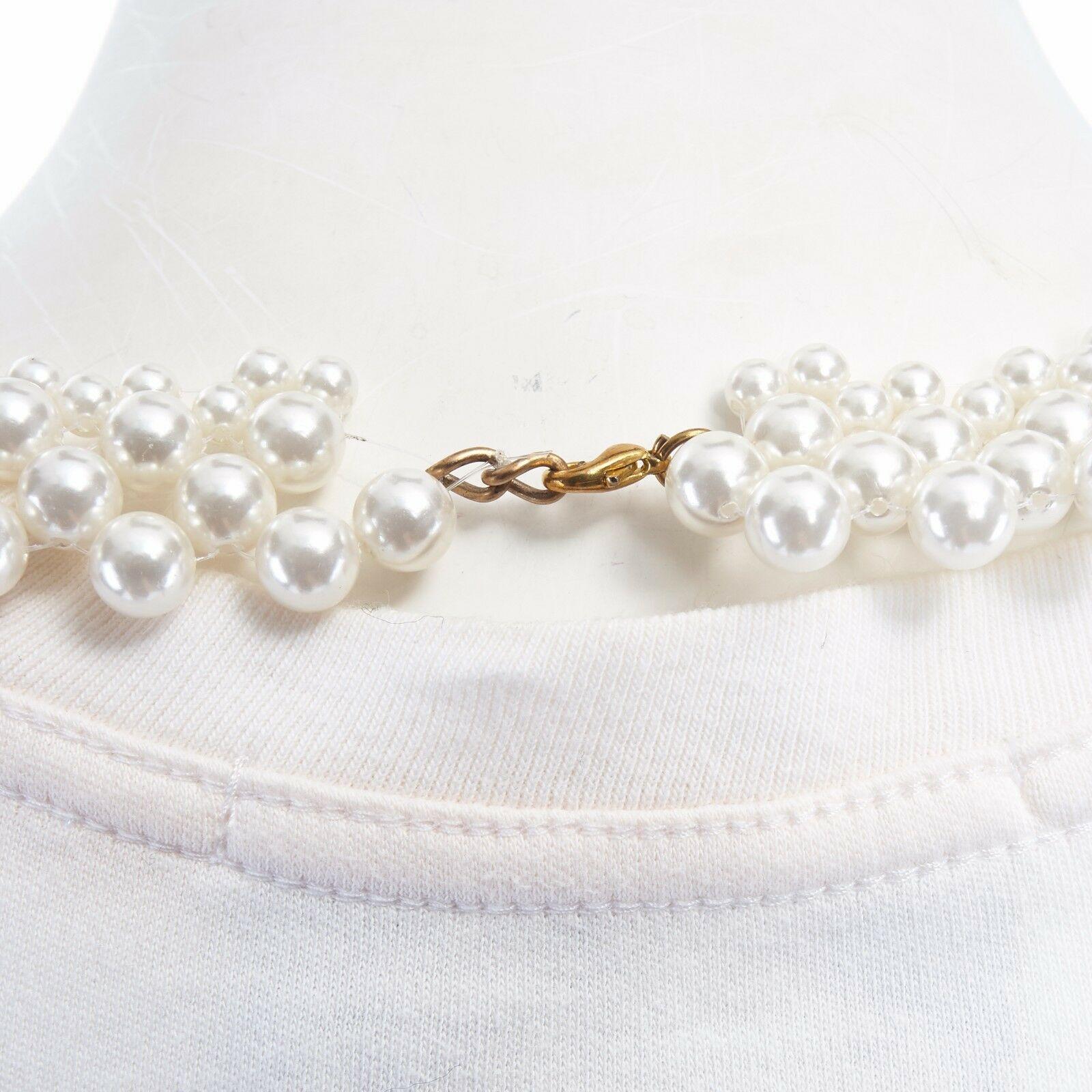 SIMONE ROCHA white cotton pearl necklace sleeveless cropped tankl top UK8 XS
Brand: Simone Rocha
Designer: Simone Rocha
Model Name / Style: Pearl necklace tank
Material: Cotton
Color: White
Pattern: Solid
Extra Detail: Attached pearl necklace.