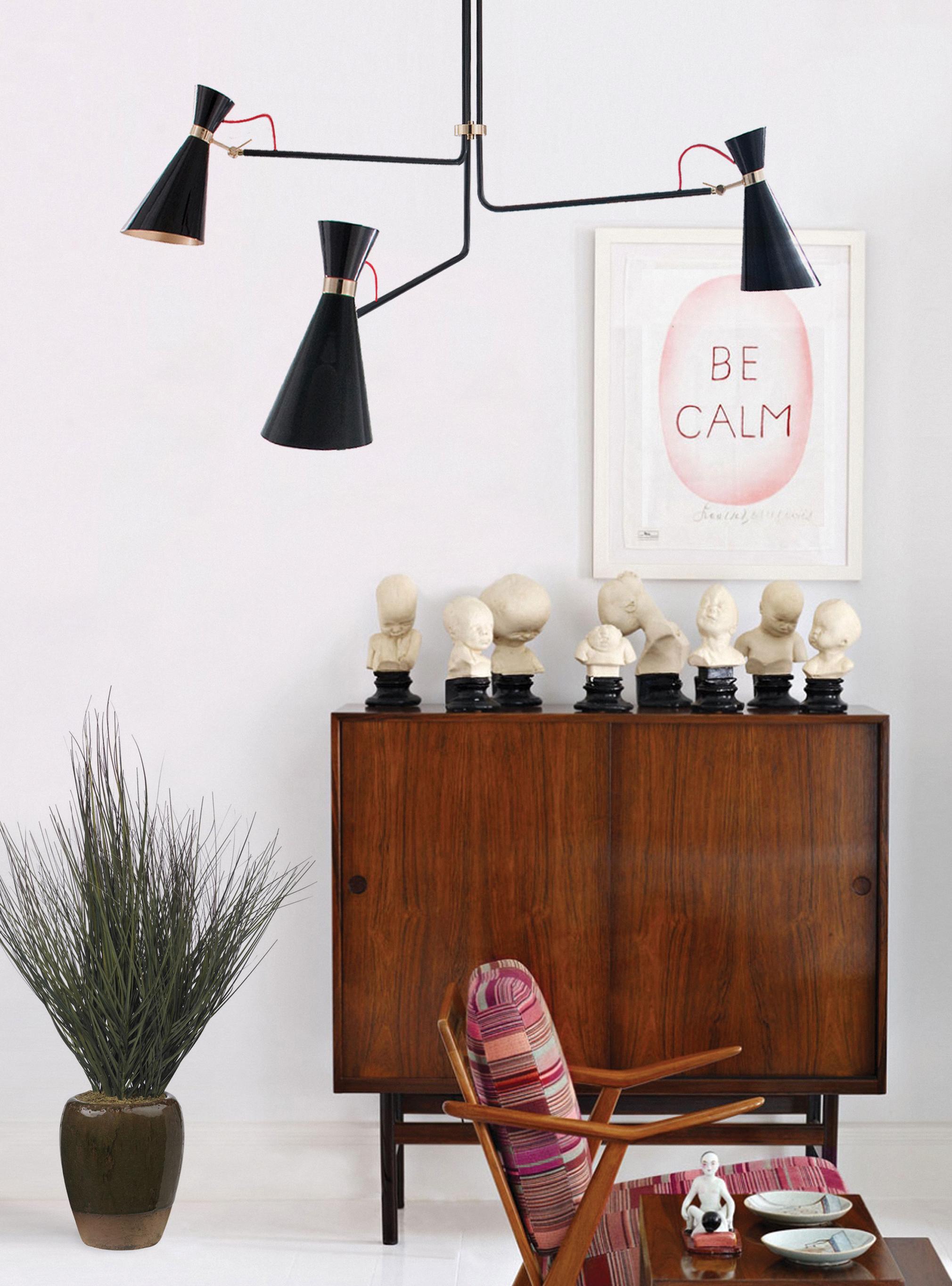Nina Simone was the inspiration for this dazzling Mid-Century Modern chandelier. Handmade in brass, this modern lamp has three lamp shades in aluminum that feature a glossy black finish and three visible textile red wires above the large lamp