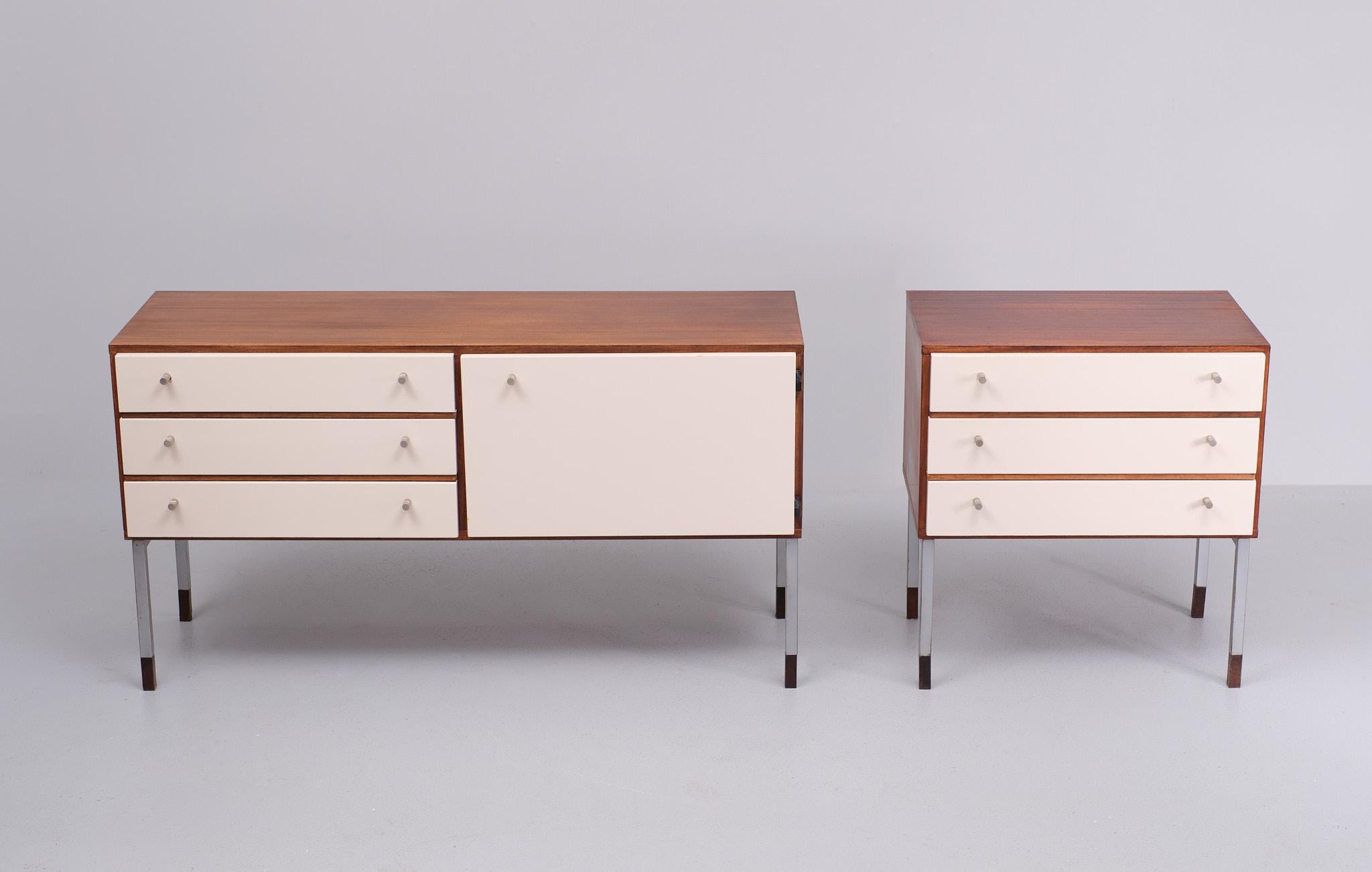 Love this matching set .Small sideboard and cabinet . Teak top .and off White 
laminated fronts . Nice Teak details . Teak socks . Square metal legs .
1970s Holland by Simpla Lux 
