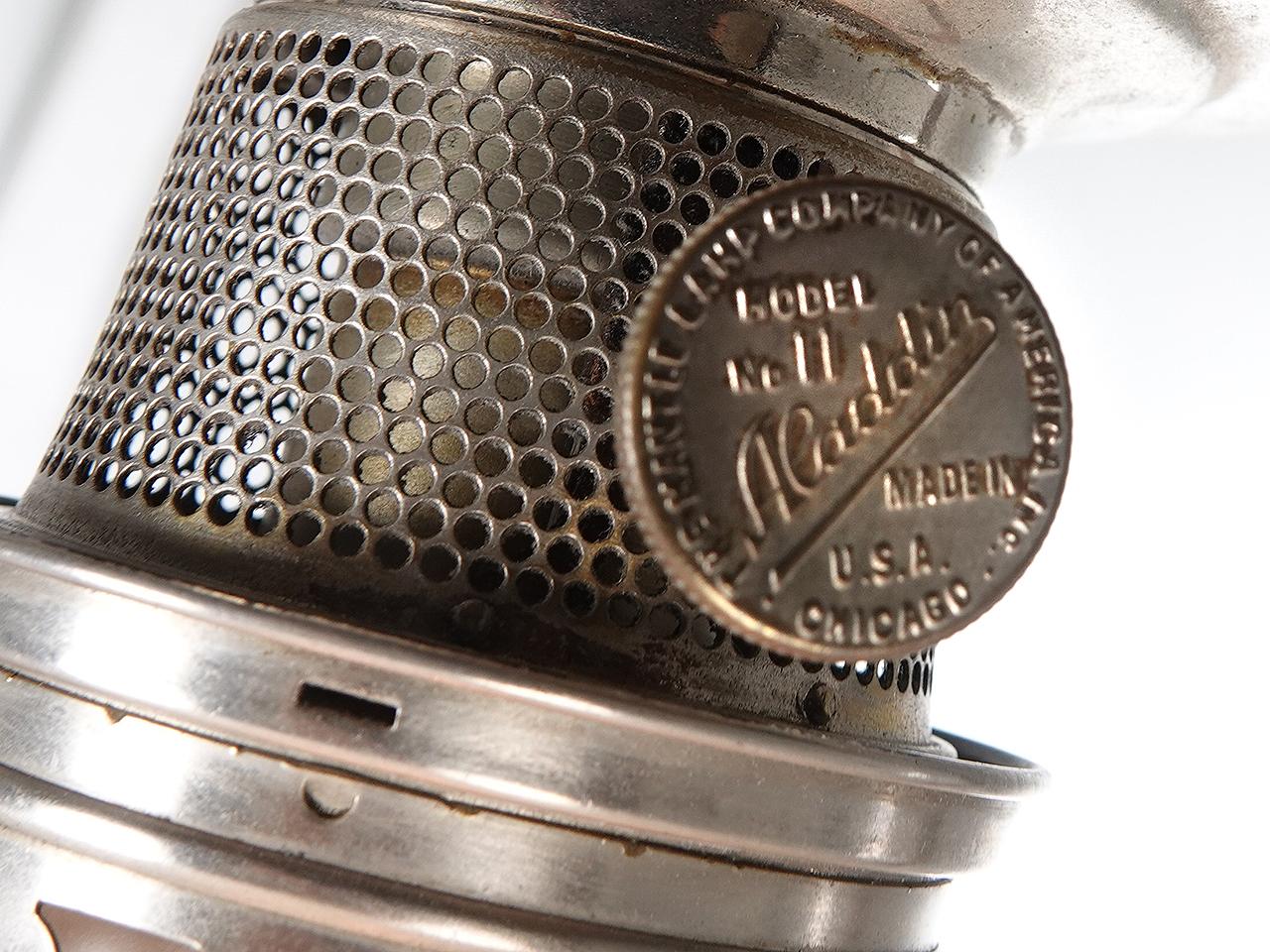 This is an early oil lantern signed Aladdin Lamp Co. Its nickel plated with a nice tented 14 inch diameter milk glass shade. It has been rewired and now uses and E26 size bulb.