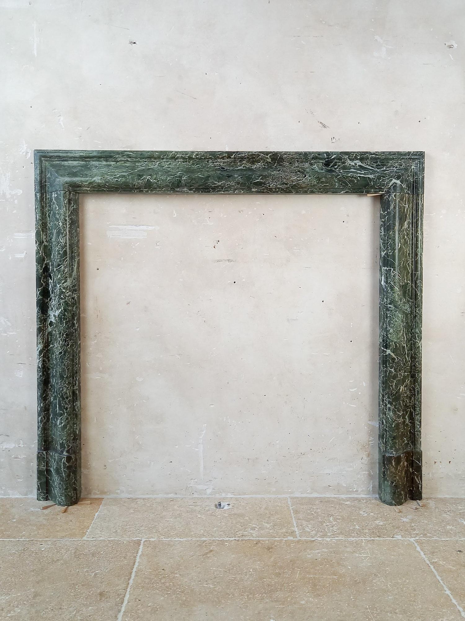Simple and elegant antique Italian green marble fireplace, 19th Century Italy. Mantlepiece made of green marble (Vert Patricia) en sleek elegant lines. Beautiful antique piece that works great in a modern interior.

dimensions: H 106 x W 118 x D 7