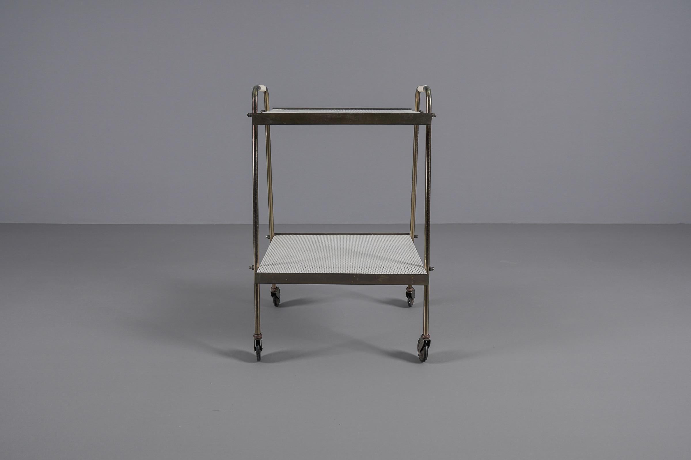 Metal Simple and elegant brass and perforated metal bar cart in the manner of Mathieu 