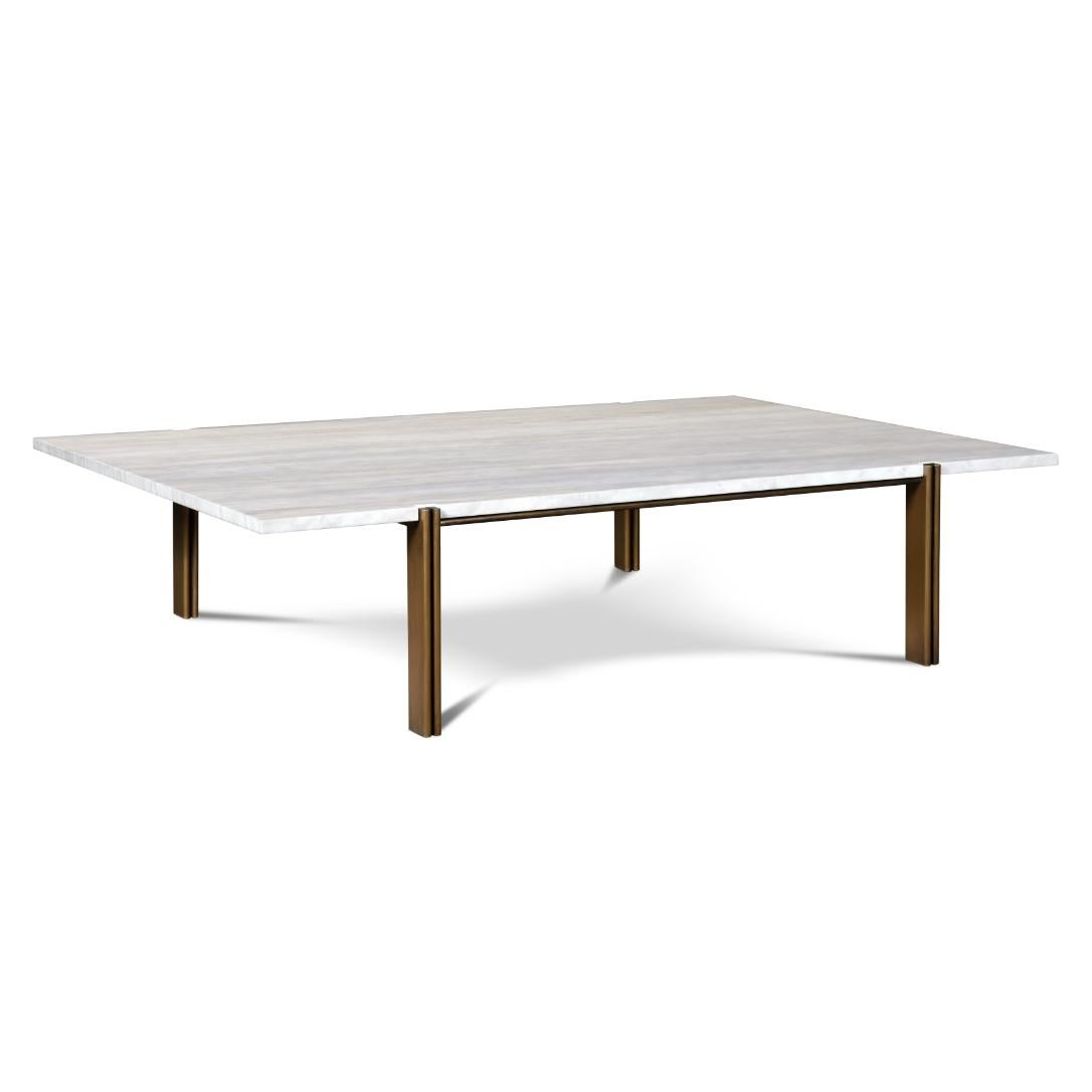 It is a simple and elegant cocktail table with carefully crafted details. The white marble tabletop contrasts with the brass base. The legs are formed by two brass plates with curved edges and has a dark wood inlay between them.
 