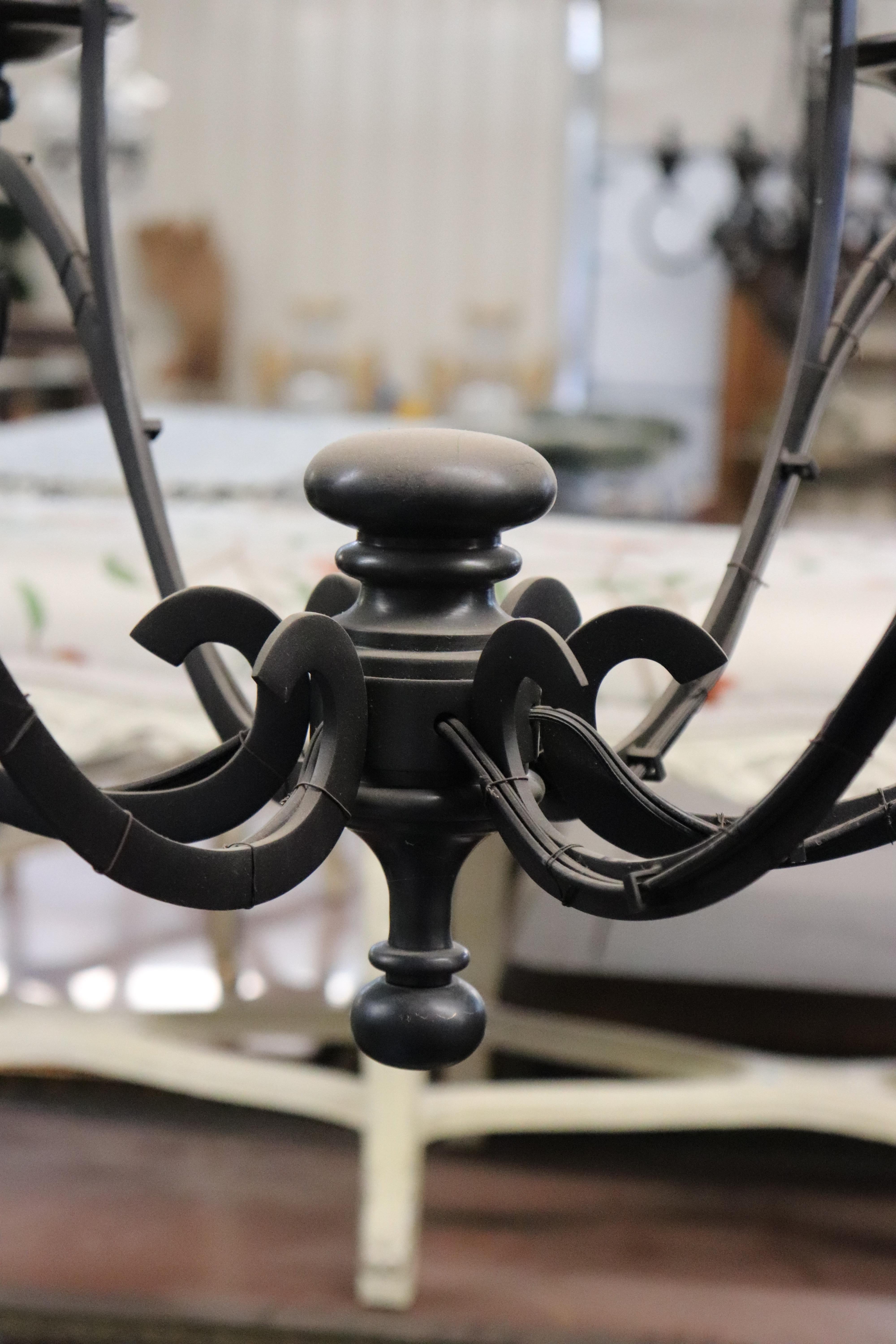 This is a simple and yet sophisticated Spanish colonial style wrought iron chandelier. There are 6 lights. Good condition. 

Measures 34 diameter x 32 tall...