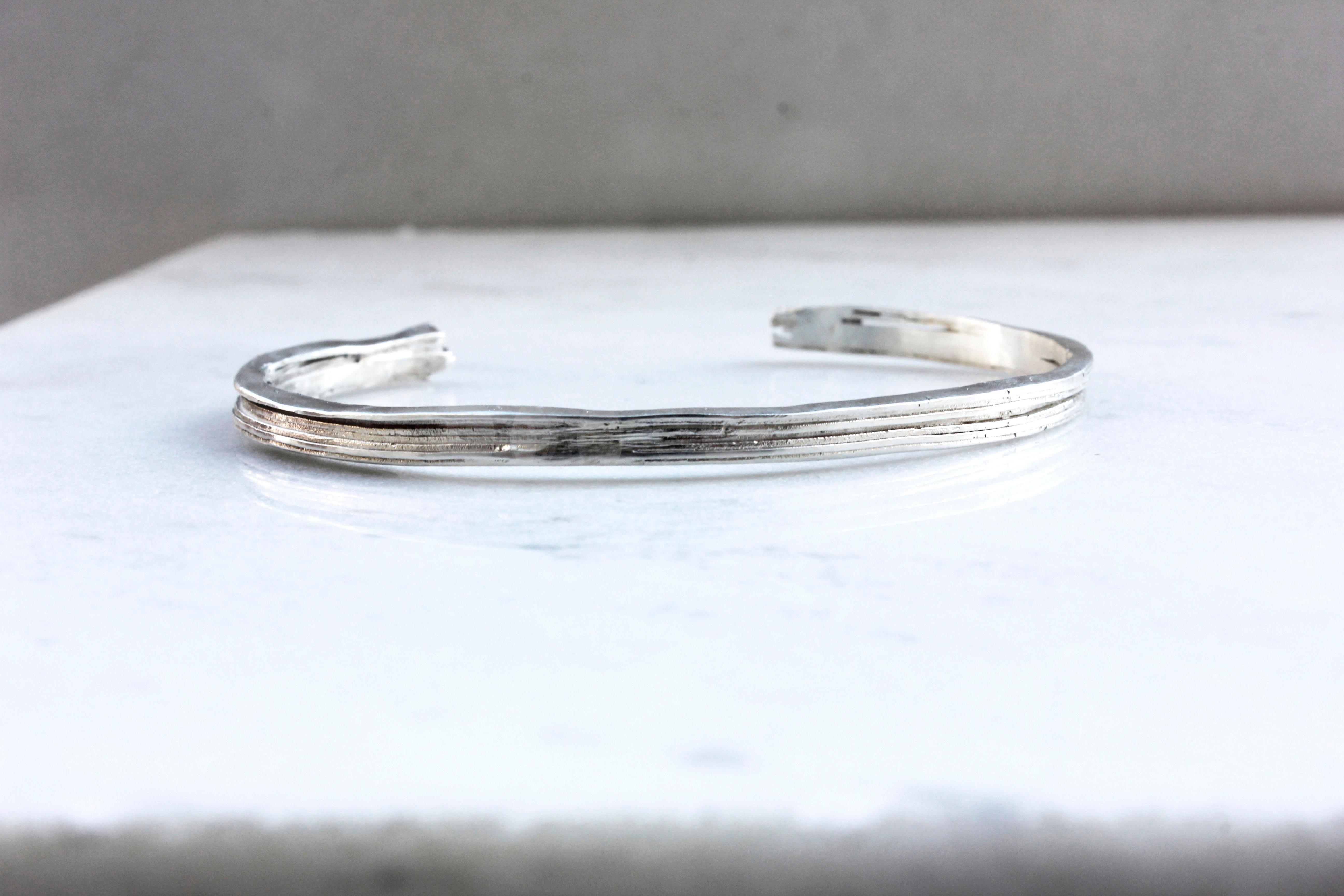 Made from eco silver sheets soldered together to create this unique texture of layers.

The bracelet is part of project_x, a collection inspired by the electronic music era.


