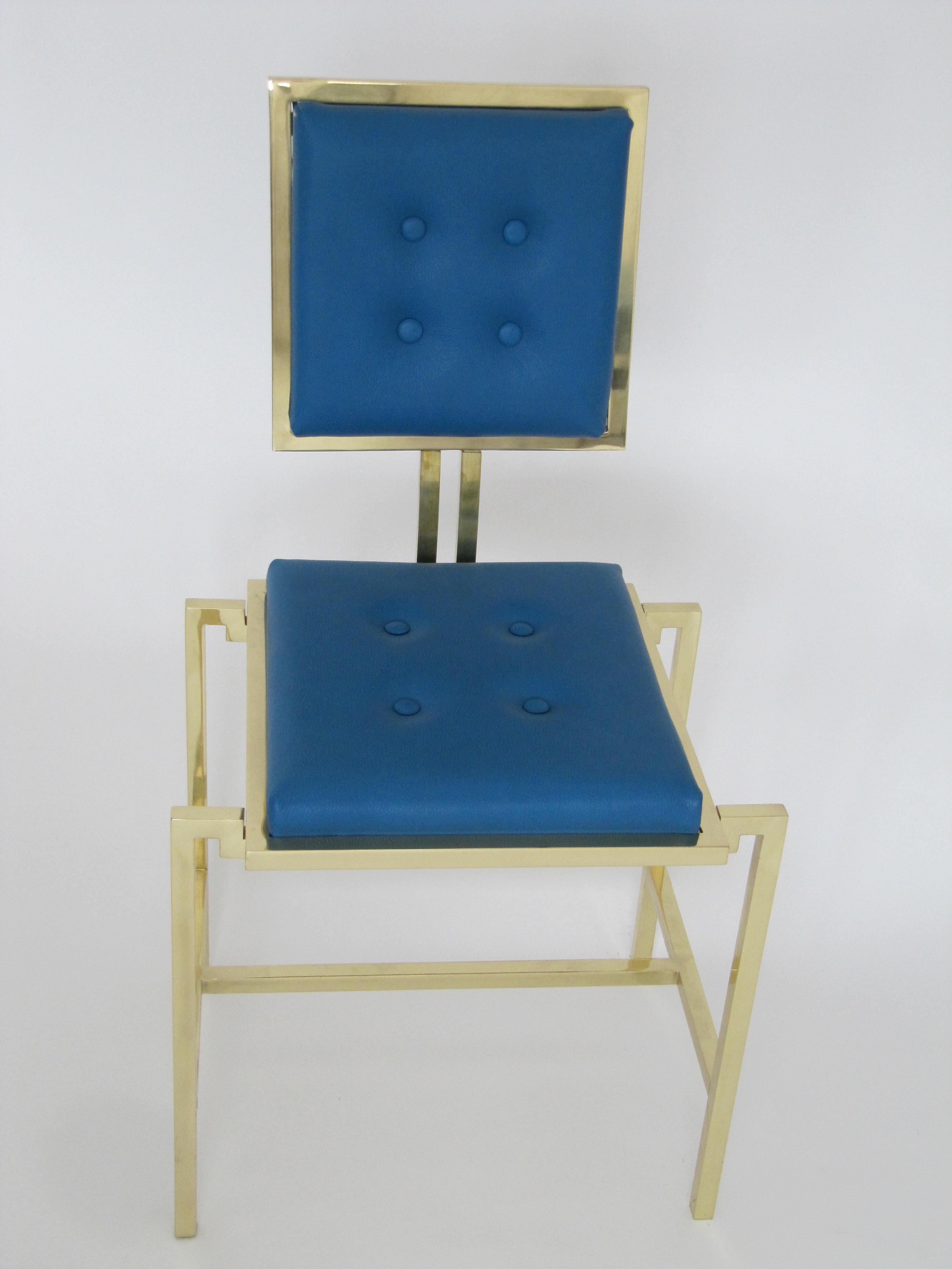 A simple yet elegant chair in authentic blue leather with solid lines framed with gold painted brass. For sophisticated or simple contemporary setting. 

Measures 45 cm x 45 cm x H 100.