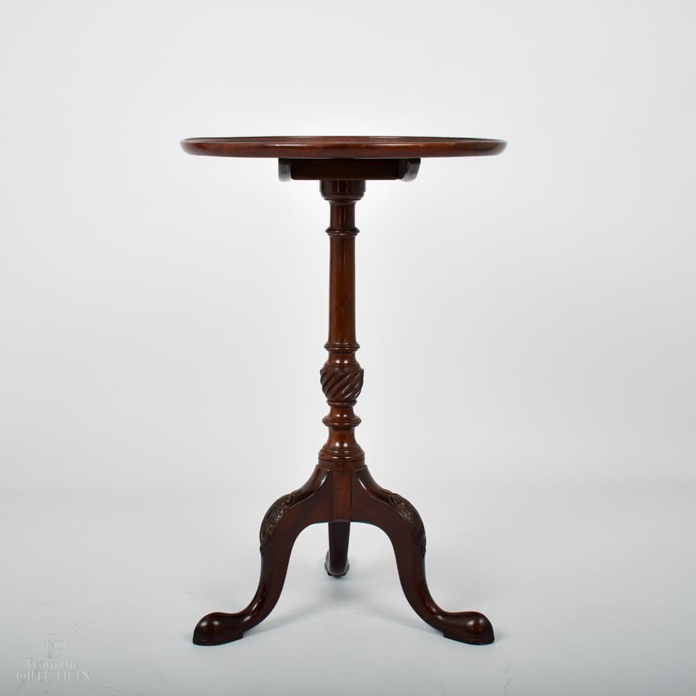 A fine Mahogany tilt top pedestal occasional table circa 1770. Such tables would often have been used as either wine tables or candle tables. The three splayed finely carved legs onto pad feet each with carved detailing. The pedestal also with