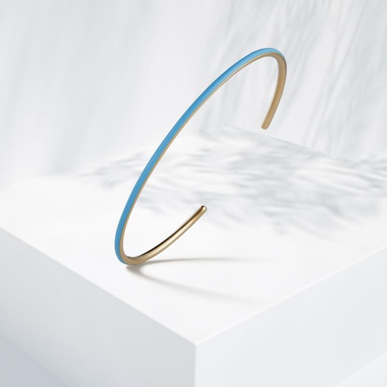 14k yellow gold cuff with baby blue enamel.

Handmade at SUEL Atelier with love and care.

2.15mm width.