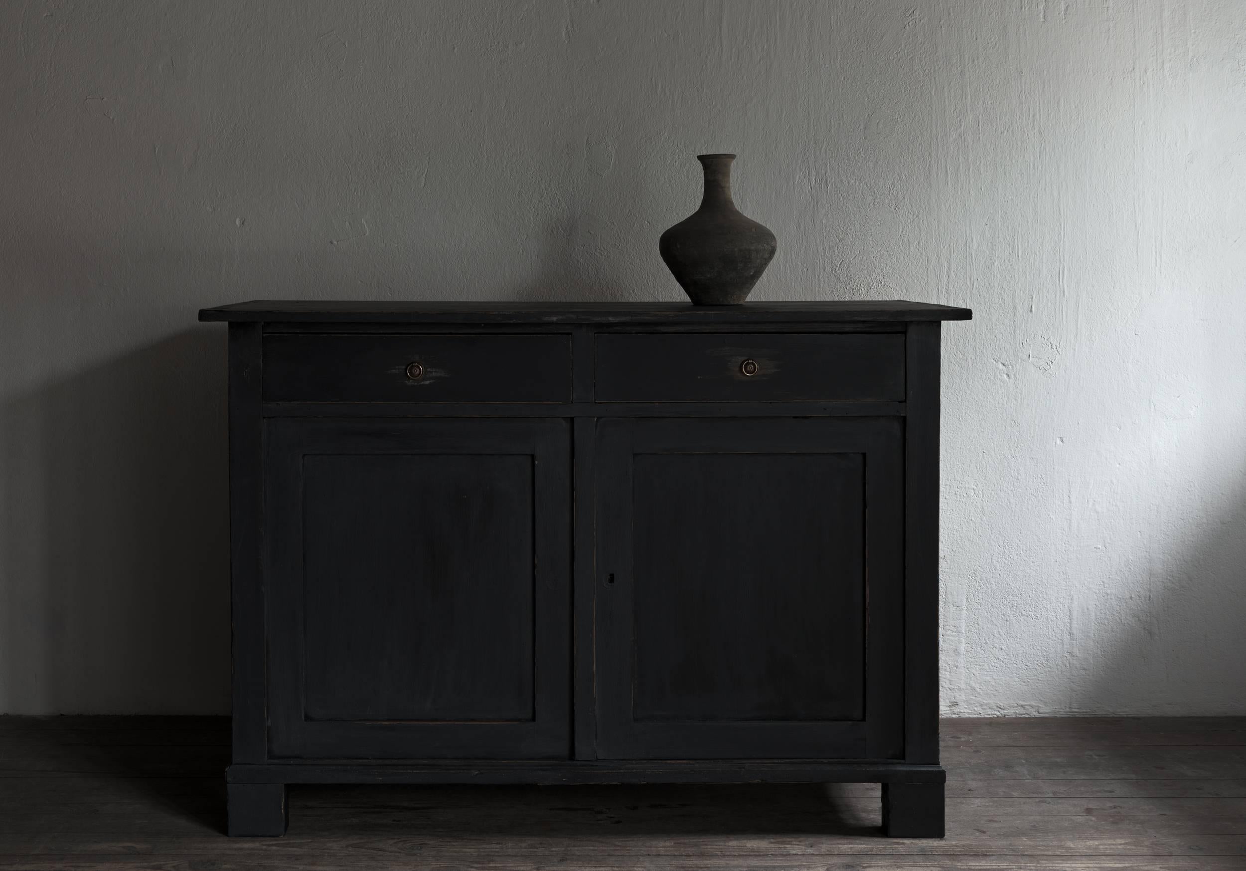 A beautiful simple black painted buffet, late Gustavian/Empire. Very chic, clear lines.