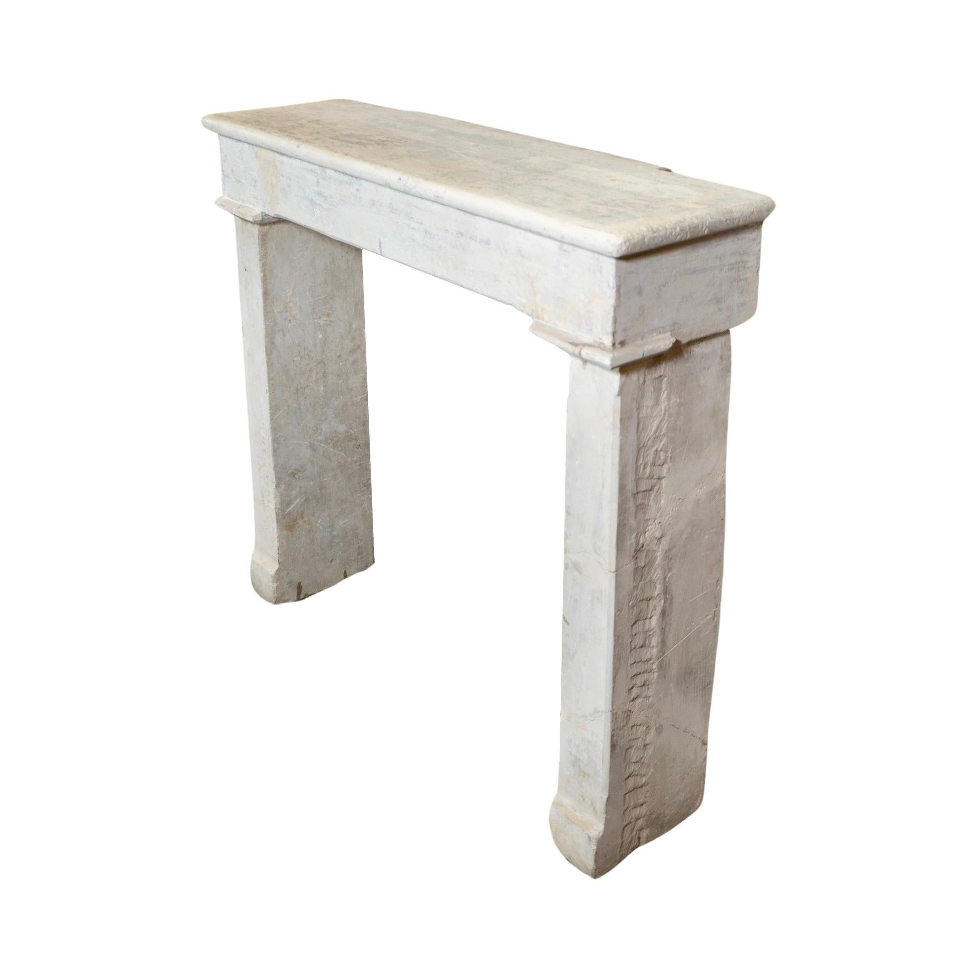 This French Limestone Mantel brings the beauty and history of 18th century France into your home. Its farmhouse design, inspired by Louis XVI style, adds a touch of elegance. Made from limestone, this small and sleek mantel is both durable and