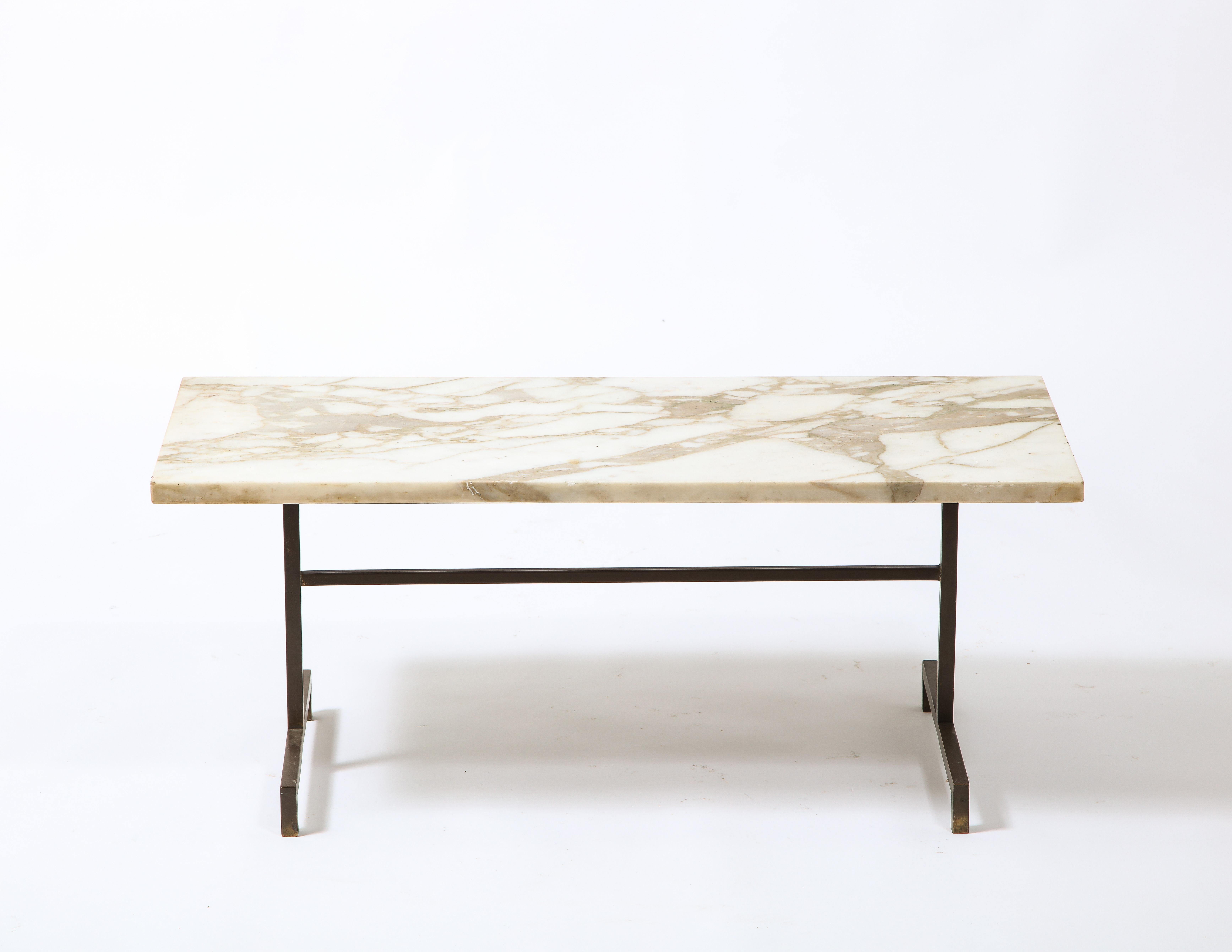 A minimalist brass and marble table in the manner of Duplantier.