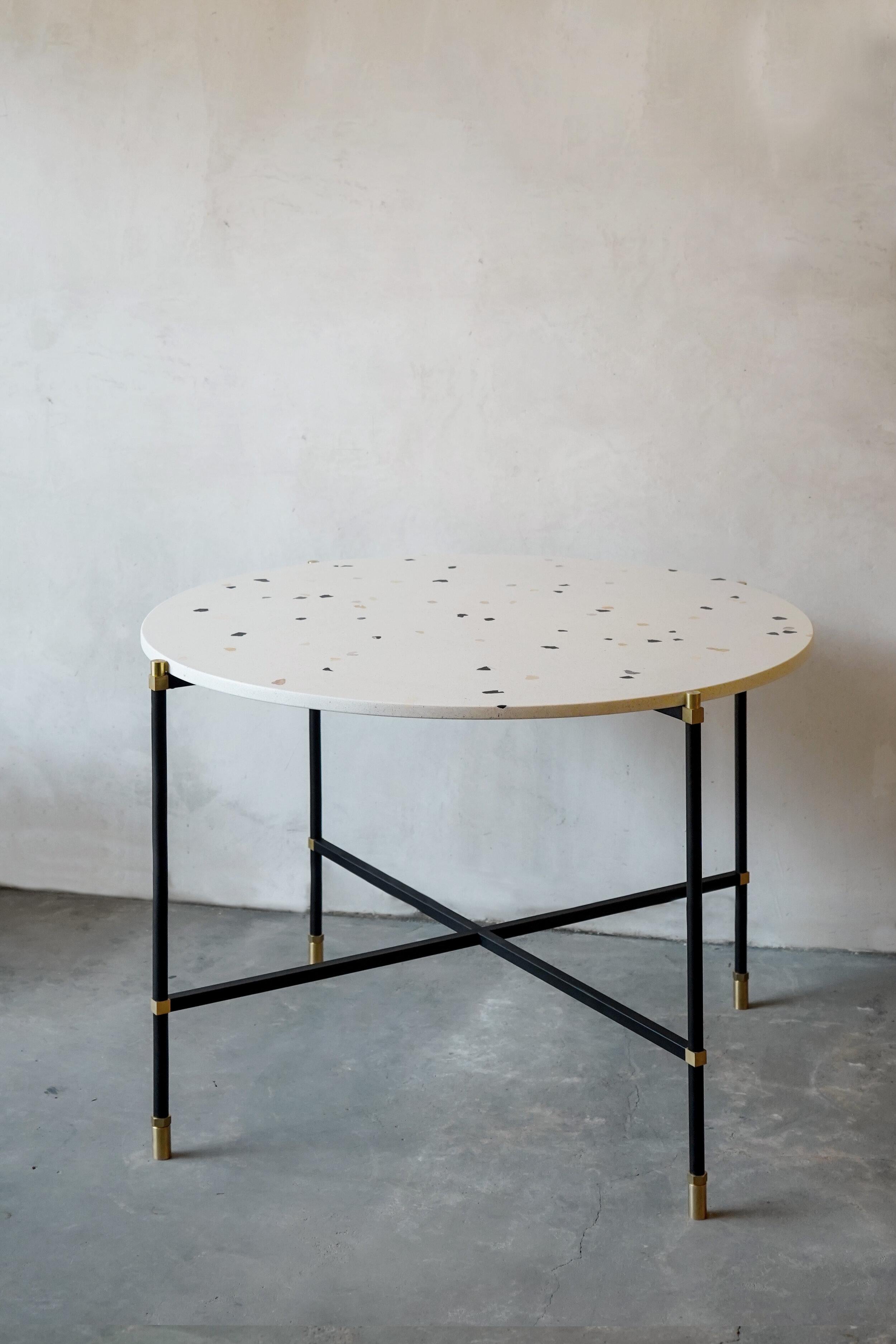 Simple round table 100 4 Legs by Contain
Dimensions: D100 x H76 cm 
Materials: iron, brass, terrazzo, marble, stone.
Available in different finishes and dimensions. 

The Connector furniture collection is based on single assembly pieces that