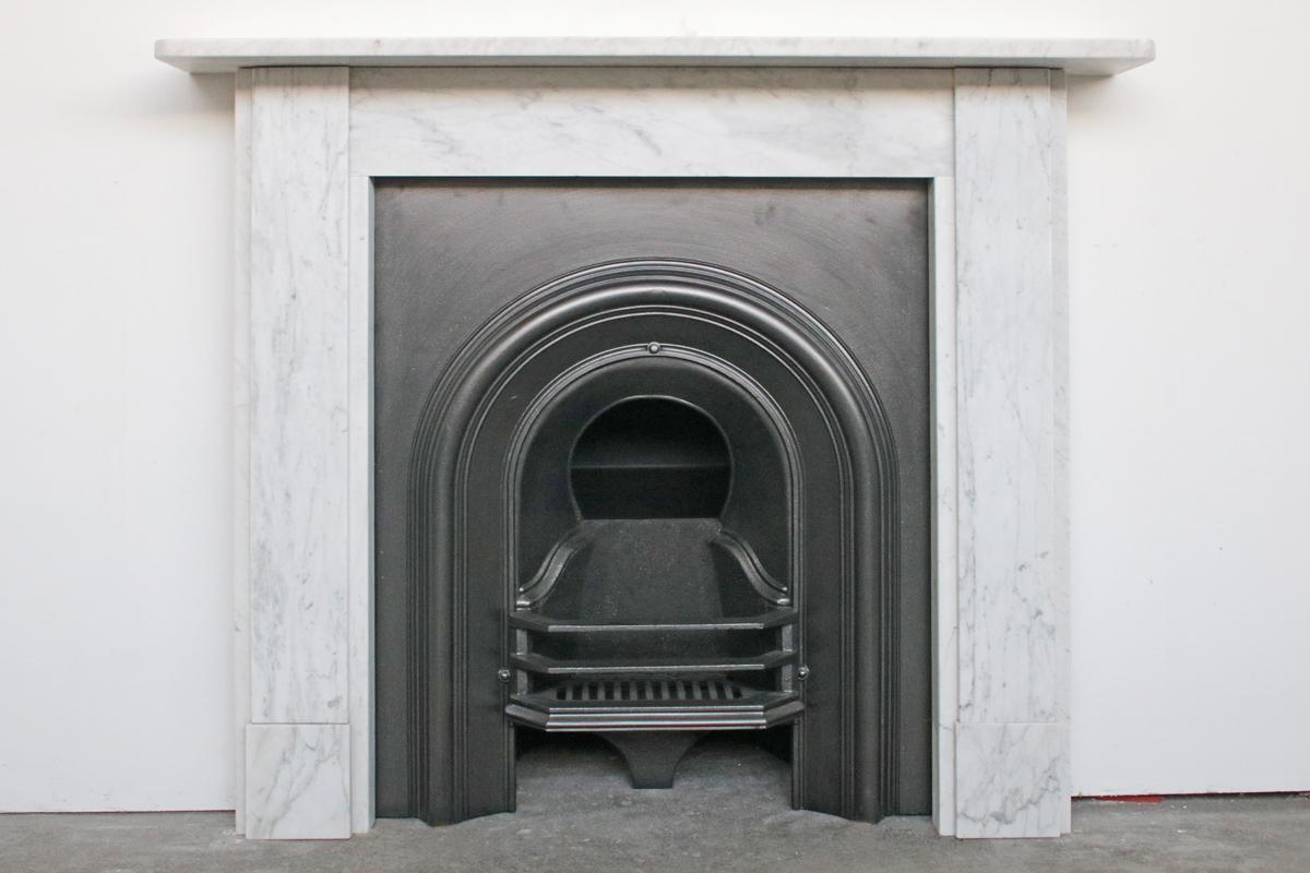 Antique Victorian Carrara marble fireplace surround of simple construction, circa 1880.
Pictured with an original Victorian cast iron insert, sold separately.
Please see the image gallery for a detailed size diagram.