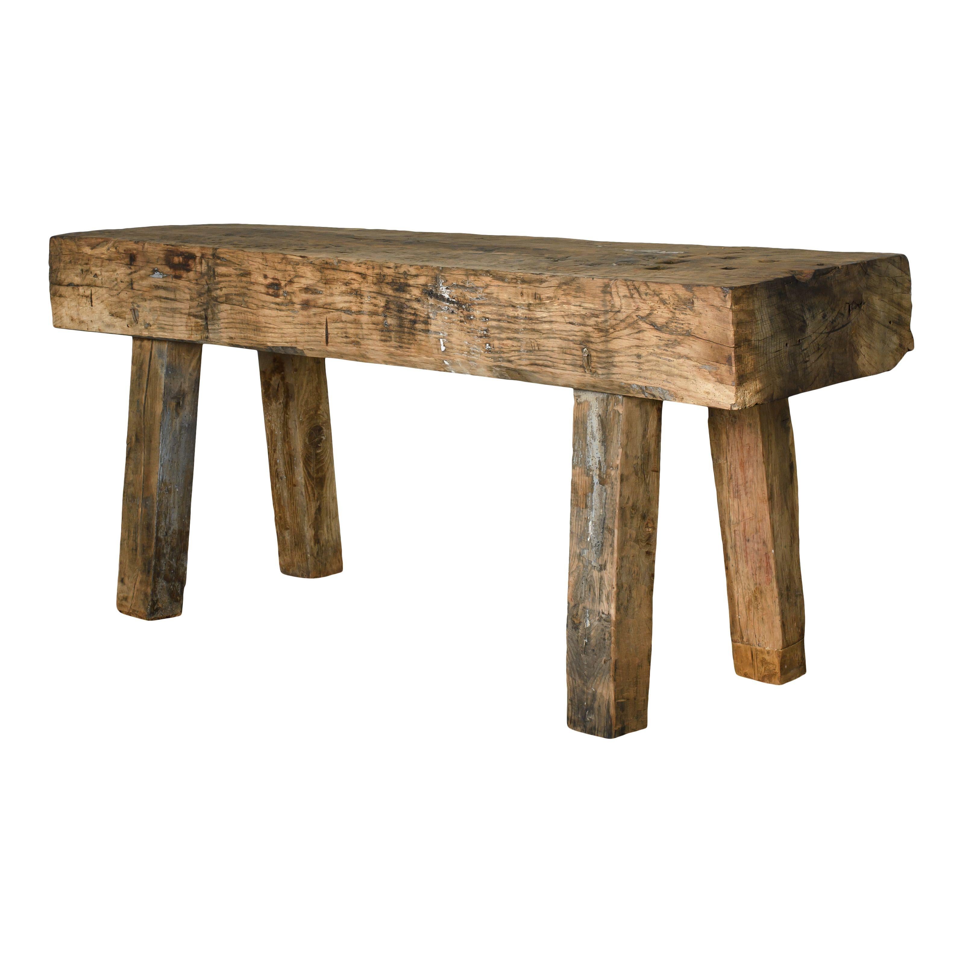 A simple yet charming vintage wood console table or sideboard with beautiful signs of ware and use. The workbench features a sturdy top and 4 thick legs, all of which show lovely signs of ware and use, giving the piece a perfect vintage patina. This
