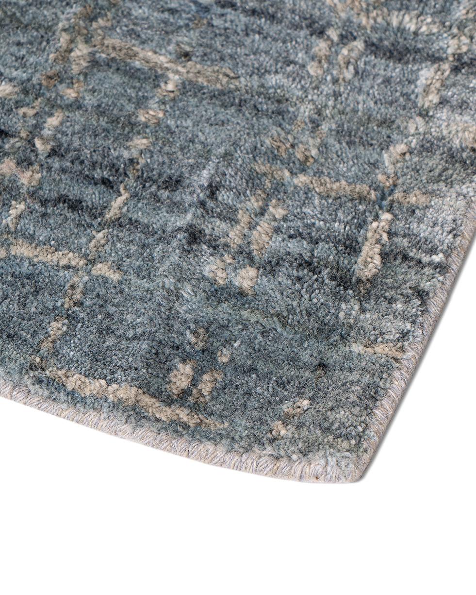 Simplicity blue gray contemporary handwoven area rug, 10' x 14'. This contemporary wool & viscose rug has a luxury firm mid height pile and creates a soft and relaxing look to any setting. Colors: Blue/gray.