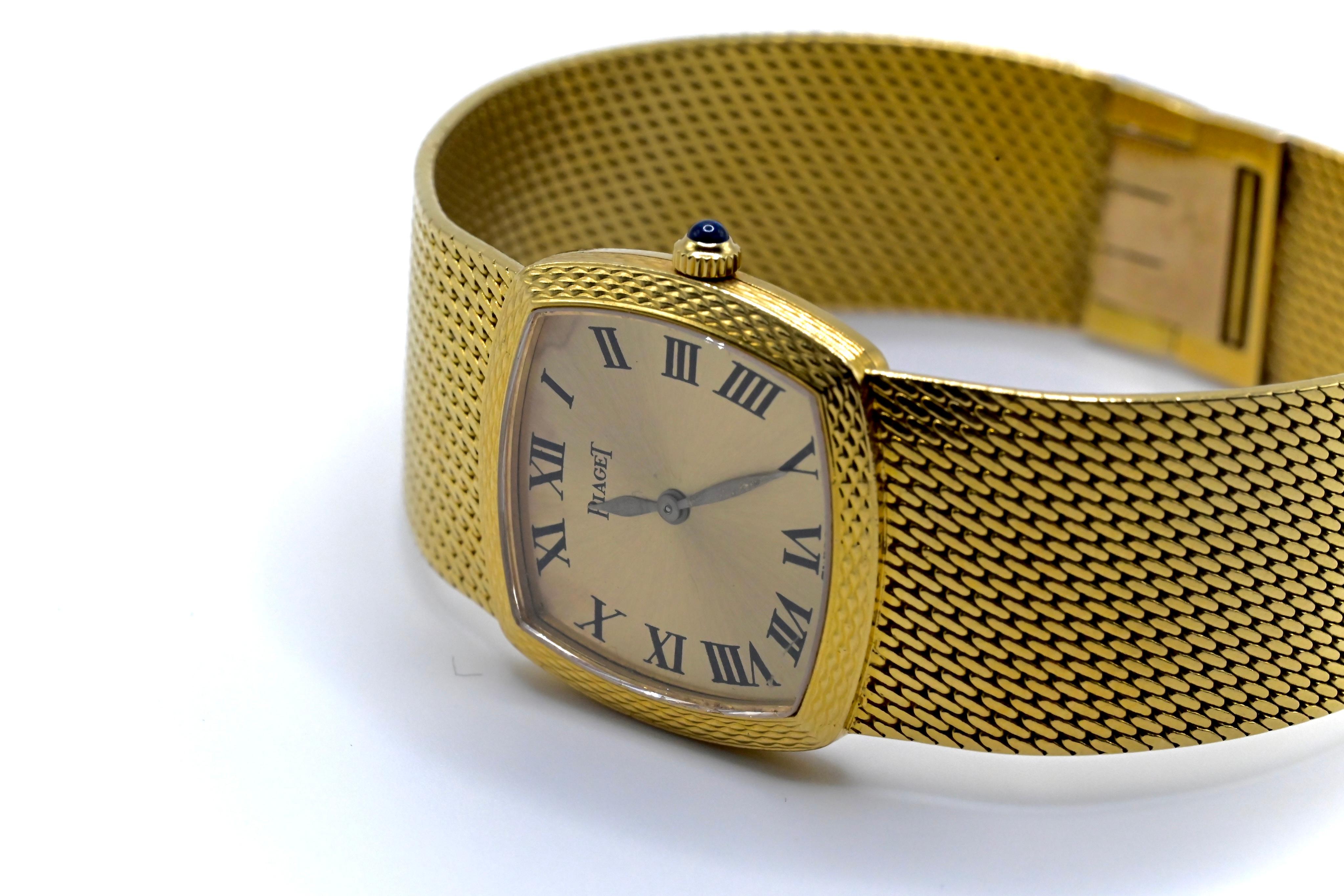 This is a beautiful, yet simplistic 18k yellow gold Piaget ladies wristwatch with a single blue sapphire on the crown of the watch. The strap length is 6 6/8 inches, its case diameter is 23mm, and overall it weighs 52 grams. Comes with 2 extra links