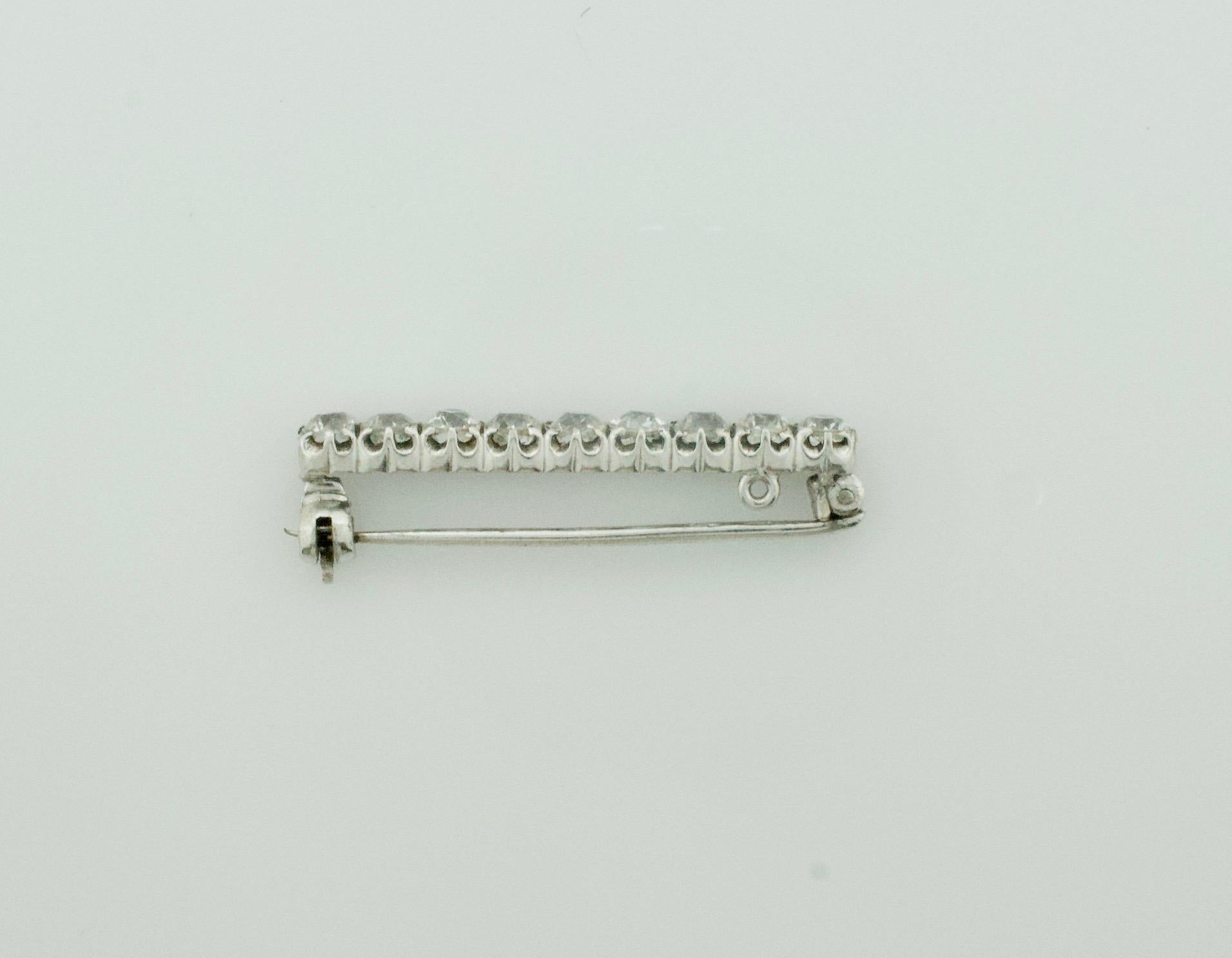 Simply Sweet Diamond Bar Brooch in Platinum and White Gold Circa 1920's
Nine Old European Diamonds Weighing 2.25 approximately   [GH VS2-SI1]
One Quarter Carat Each  