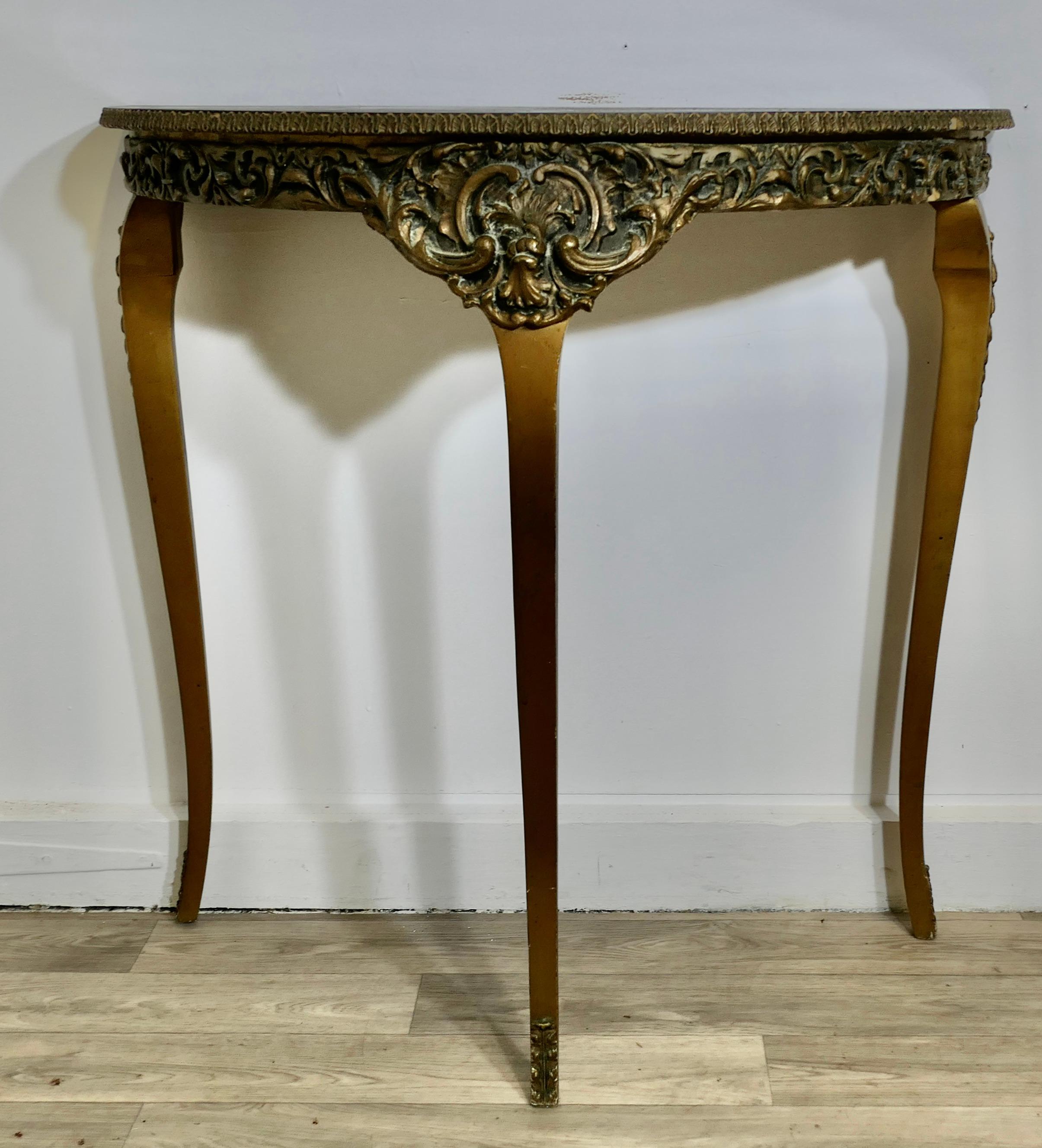 Simulated Marble and Gilt Free Standing Console Table 

This is an attractive piece, the table has a decorative shaped apron around the Demi-lune top, the top is simulated to look like marble, it stands on 3 cabriole legs
The table is in sound