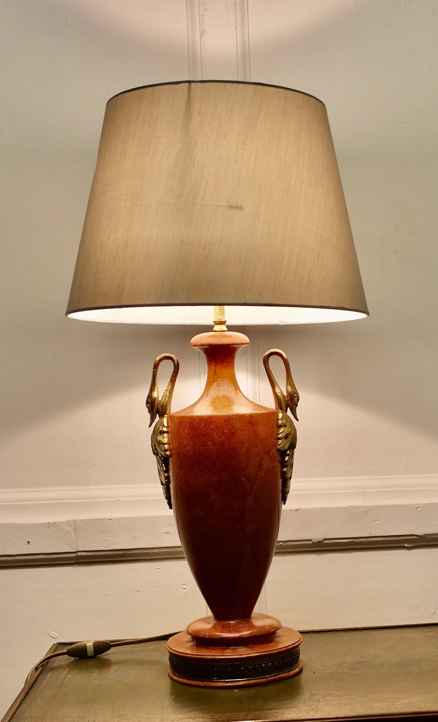 Simulated Marble, Art Deco Ceramic Table Lamp 

The lamp stands on a stepped foot and has a ceramic bowl which is made in Terracotta coloured simulated marble with Gold Handles and comes with a silver/grey shade
The lamp and shade are in good used