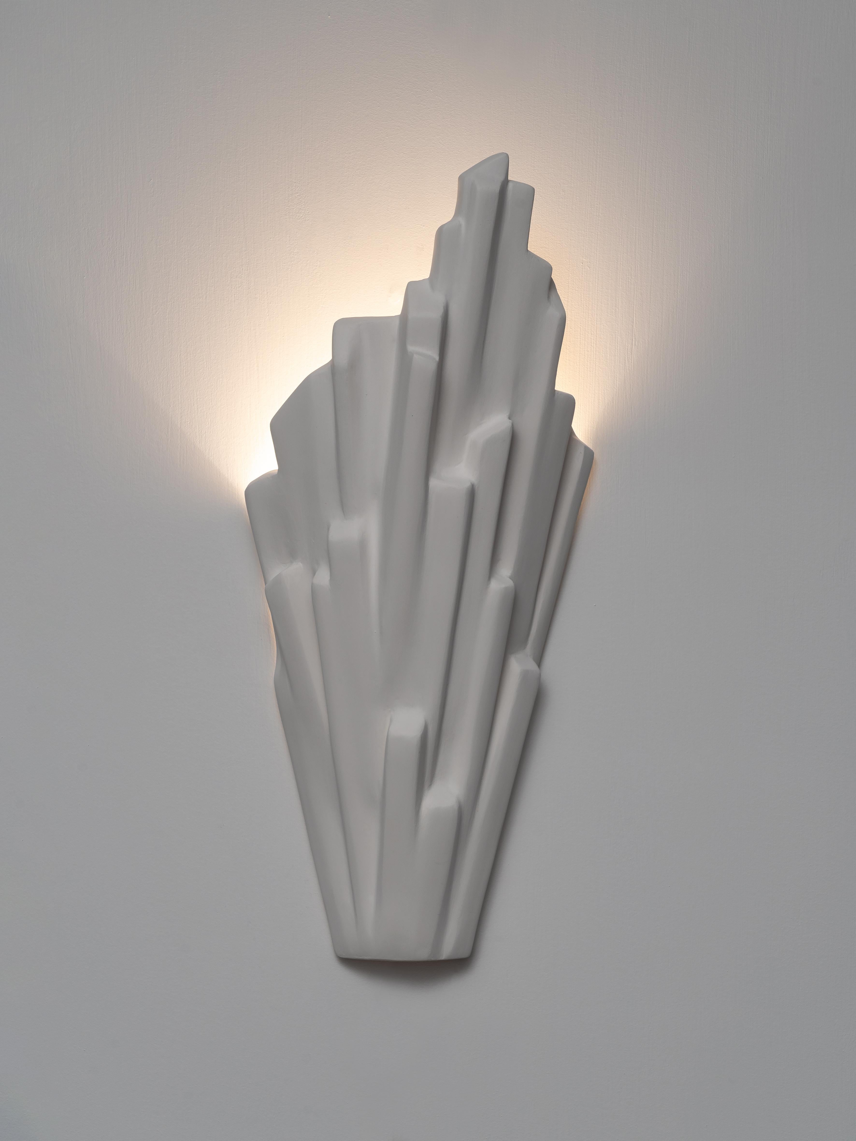 Each Sinan sconce is individually handmade, characterised by its clean, sculptural aesthetic. Hand-sculpted in silky smooth plaster. Also available in Antique Gold Finish or Black Plaster Finish with Antique Gold inside. Alternative finishes