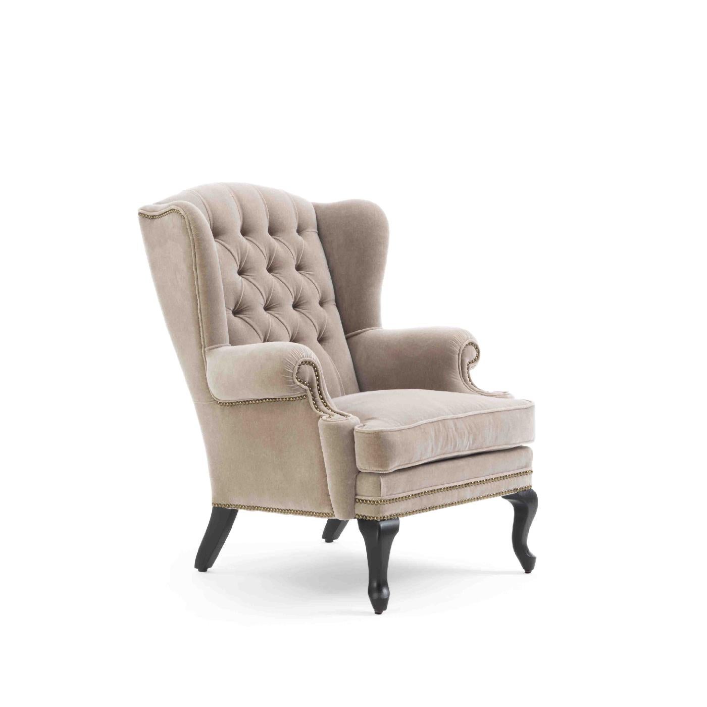 This inviting and sophisticated armchair has a strong visual aesthetic that will enliven a classic living room or private studio. A modern take on the wingback style, this piece has a solid wood frame and ash legs with an ebonized finish. Entirely