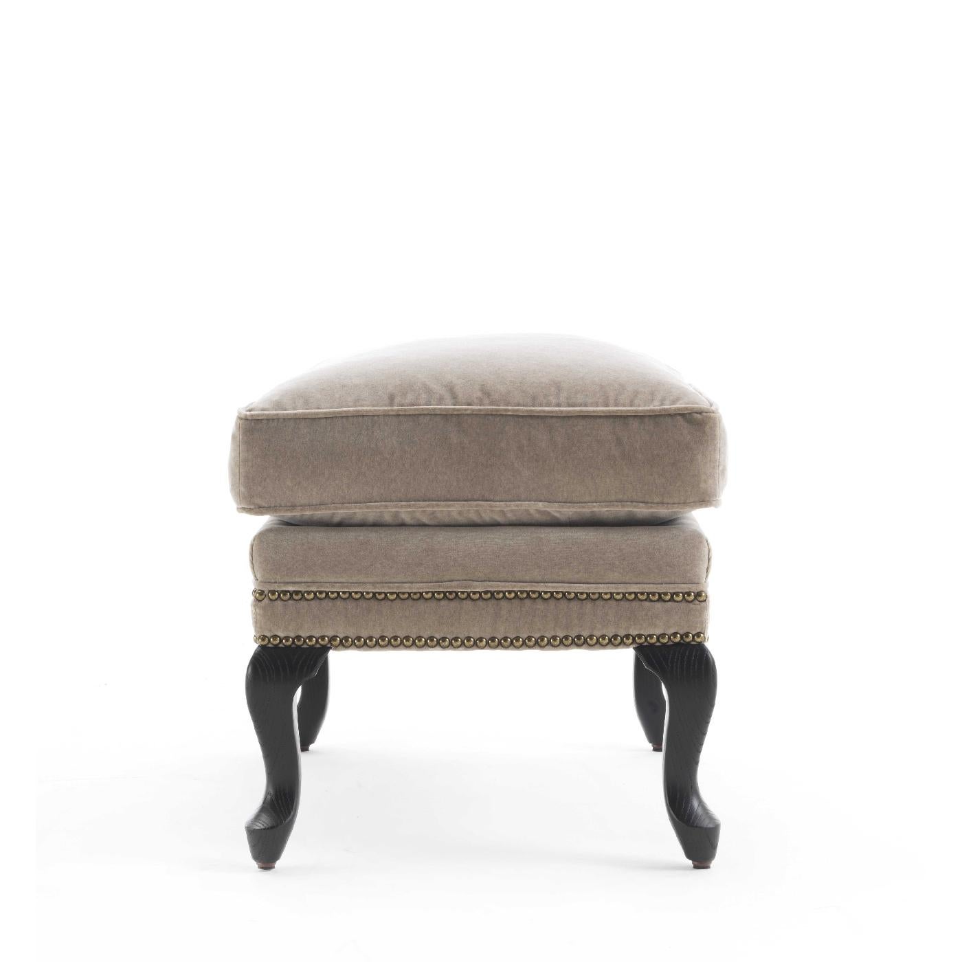 Part of the Como collection, this midcentury-inspired ottoman is the perfect complement to the Sinatra armchair, a set that will enliven a living room or bedroom decor with timeless elegance. The wooden frame features ash cabriole legs with an
