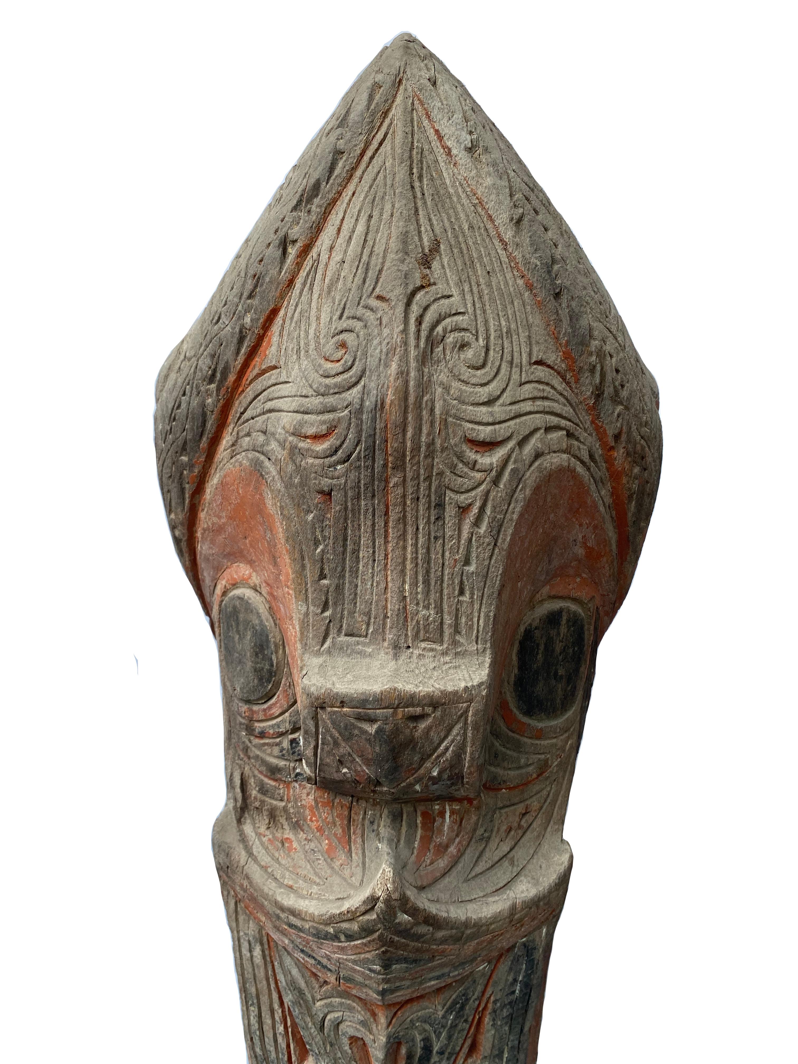 A Batak Tribe “Singa” from the Indonesian island of Sumatra. This mythical lion figure was used as a protective architectural element on the corner of a traditional Batak house. It features the traditional tri-color scheme of the Batak peoples