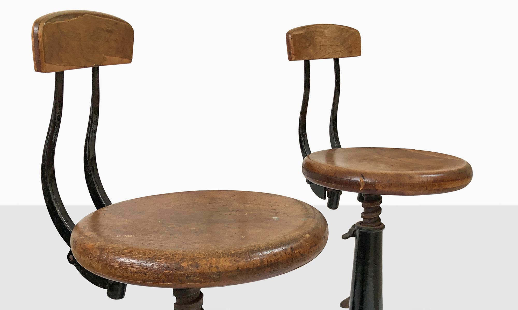 Wooden button shapes seats with sprung backrests and adjustable seat height.