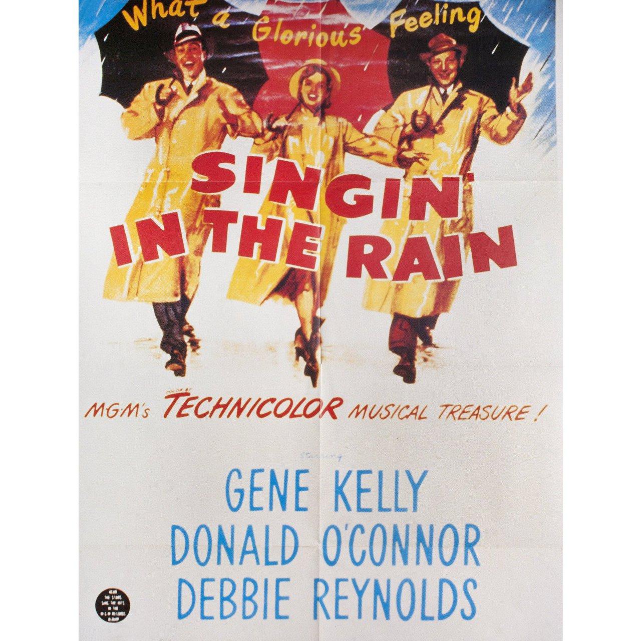 Original 2000s re-release French poster for the 1952 film Singin' in the Rain directed by Stanley Donen / Gene Kelly with Gene Kelly / Donald O'Connor / Debbie Reynolds / Jean Hagen. Fine condition, folded. Many original posters were issued folded