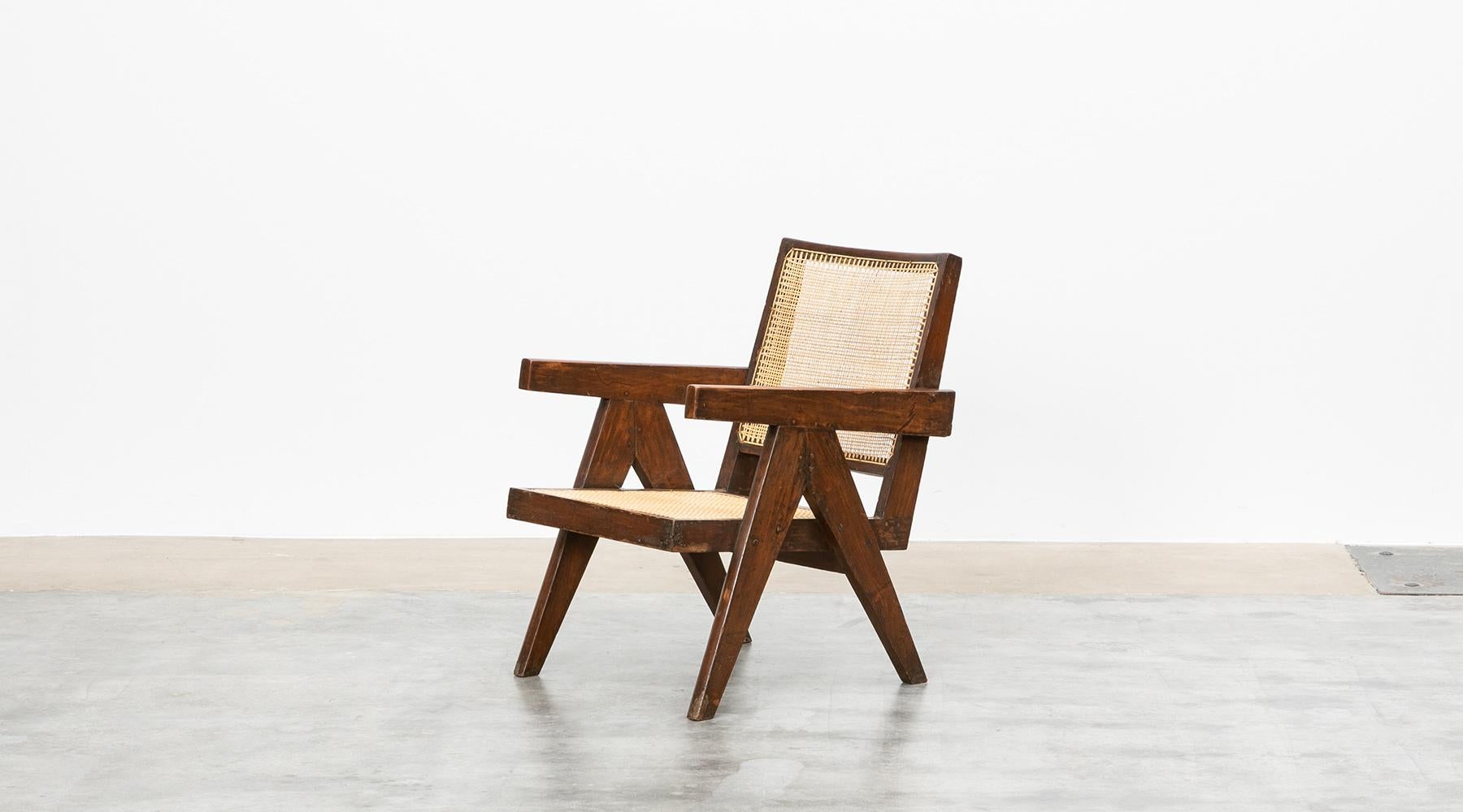 Lounge chair designed by Pierre Jeanneret in teak and cane, Chandigarh, India, 1955.

Single original lounge chair designed by Pierre Jeanneret in teak with woven cane on the seat and curved backrest appears in beautiful patina. The chair has a