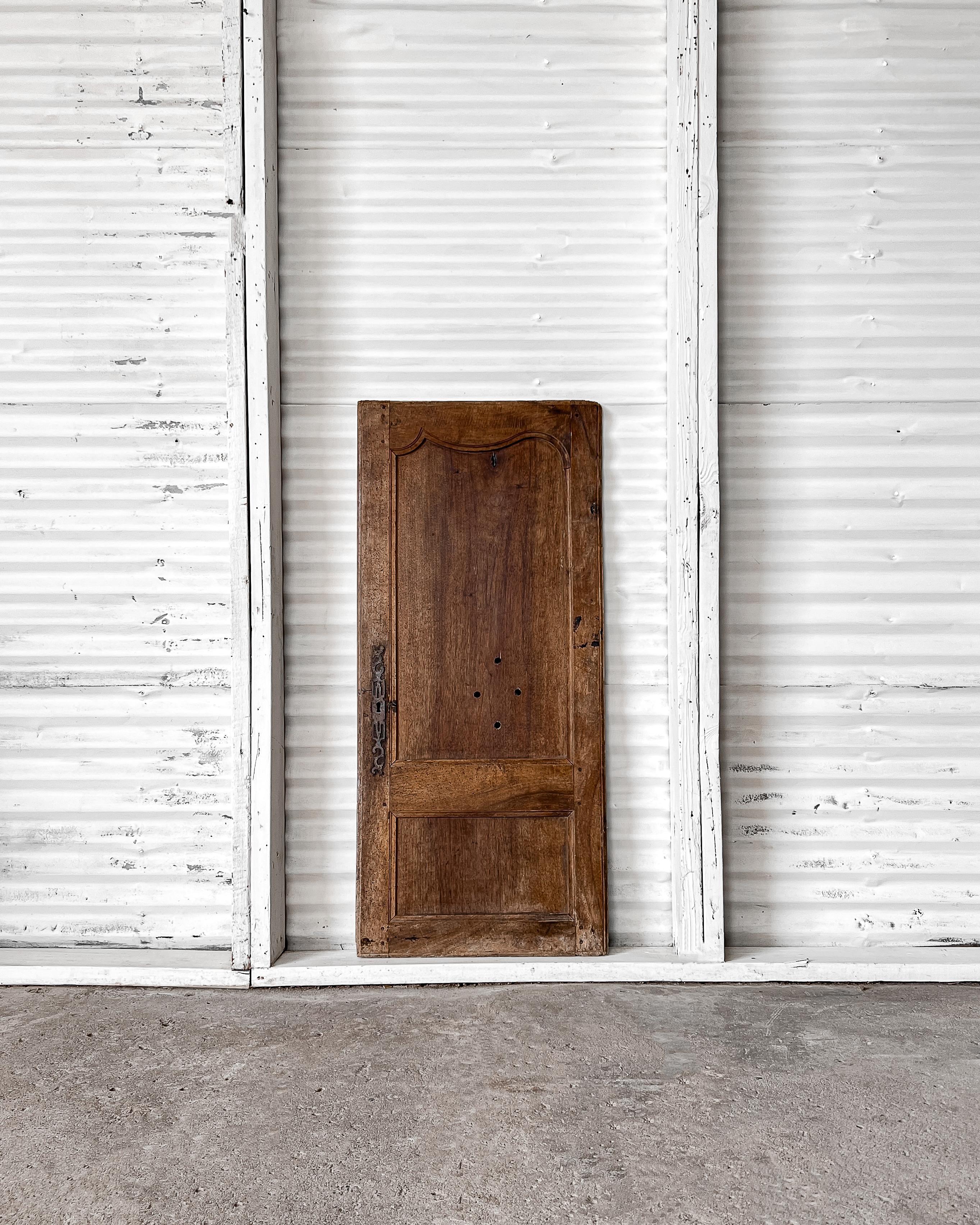 A single reclaimed provincial cupboard door with carved details. Enclose a built-in cabinet with this charming door to feel as if you’ve been transported to the French countryside.

Salvaged in France, 19th century.

Crafted from walnut with a