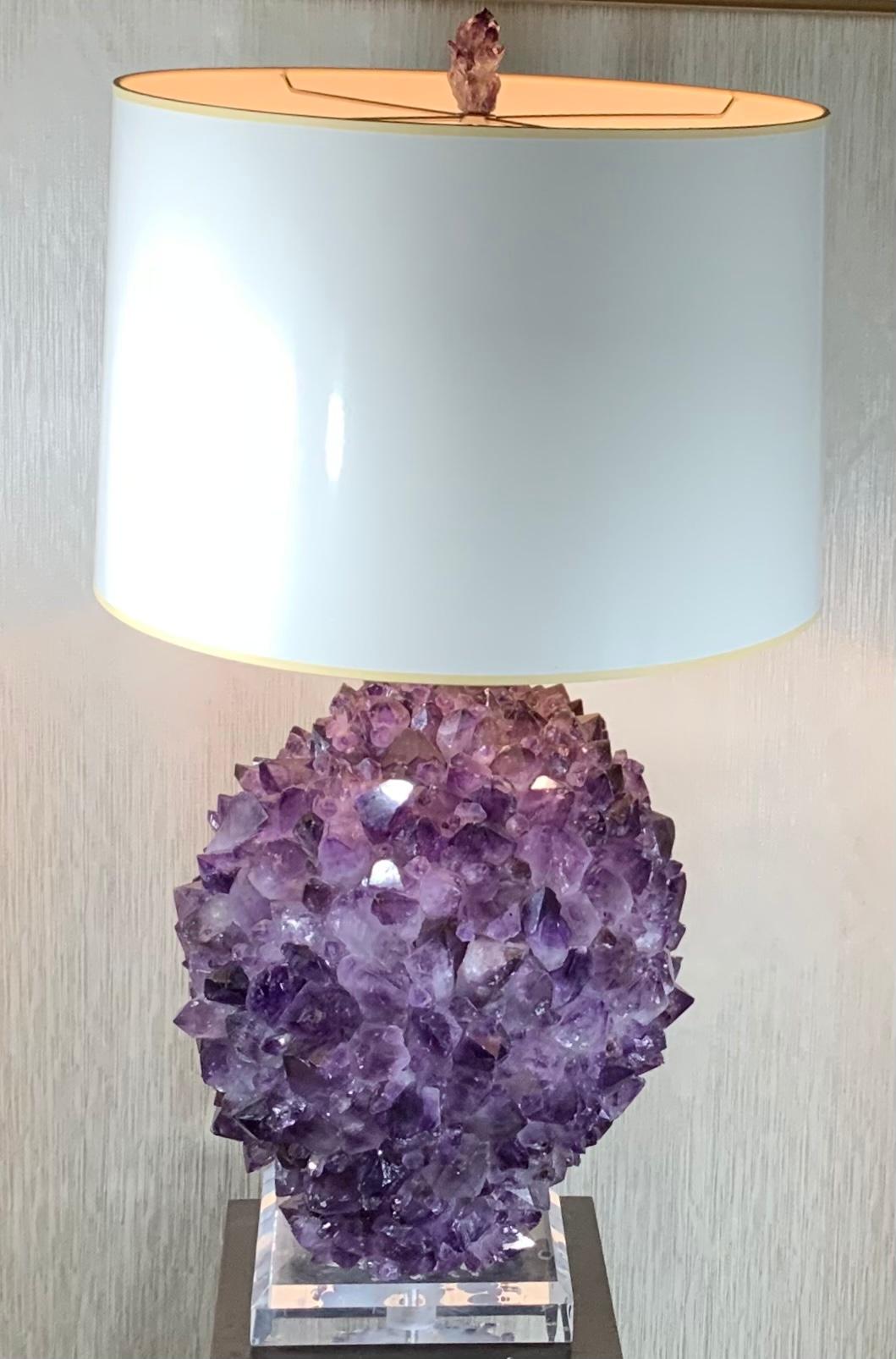 Stunning crystal table lamps, made from Genuine amethyst rock crystal in the shape of sphere, professionally mounted by the artist on beveled Lucit base. Crome hardware with 3 way light socket. Amethyst top lamp finial
Included. Shade is not