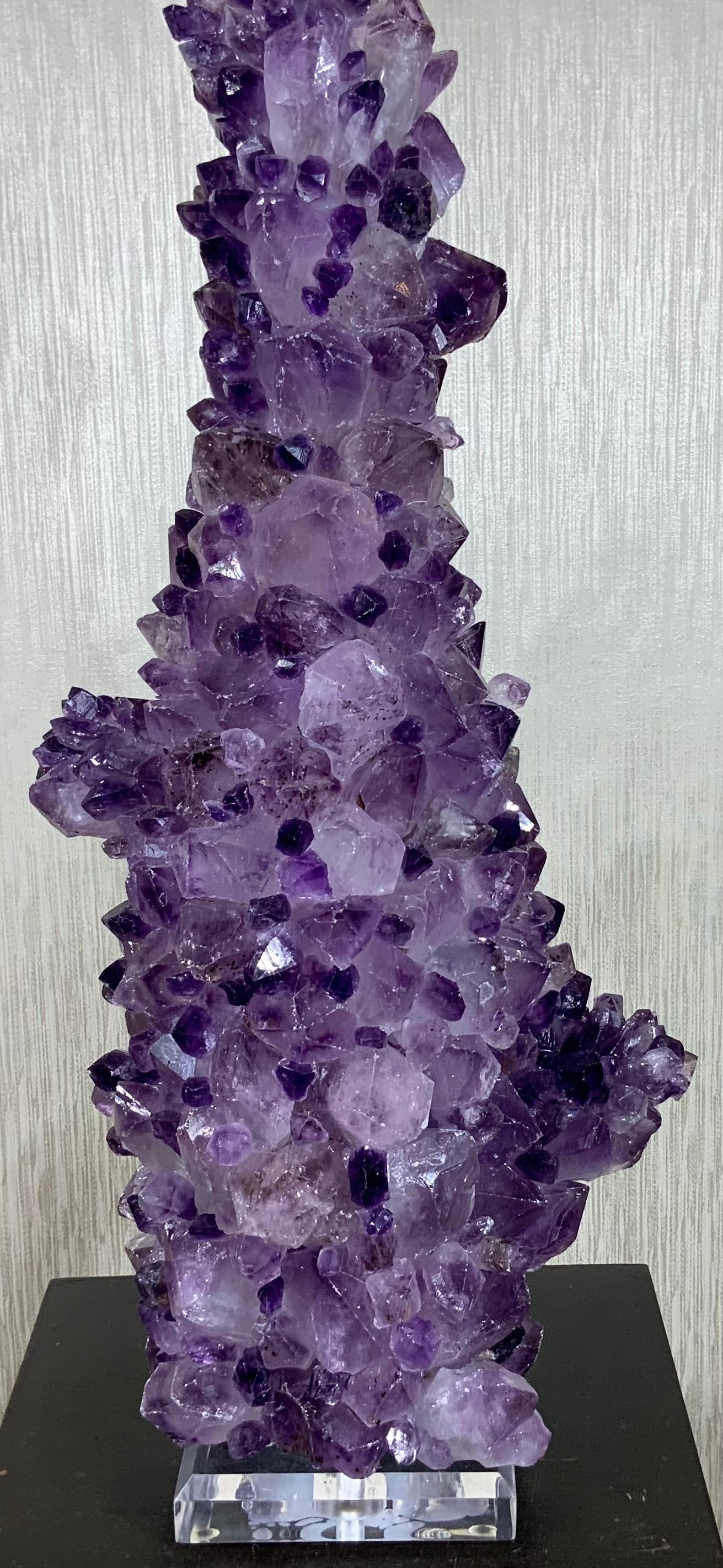 Stunning crystal table lamps, made from Genuine amethyst rock crystal in the, professionally mounted by the artist on beveled Lucite base. Crome hardware with 3 way light socket. Amethyst top lamp finial
Included. Shade is not included.
One of a