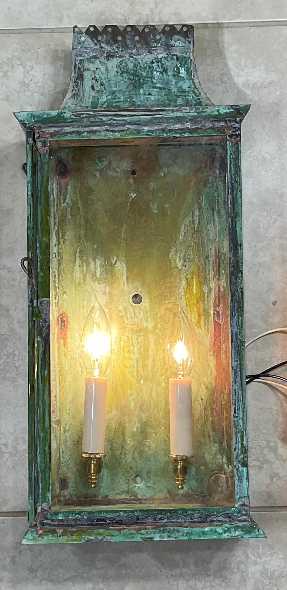 Hand crafted wall lantern made of solid copper, two 60/watt lights, clear glass, new electric hardware, suitable for wet location ready for use. Beautiful green oxidization patina.