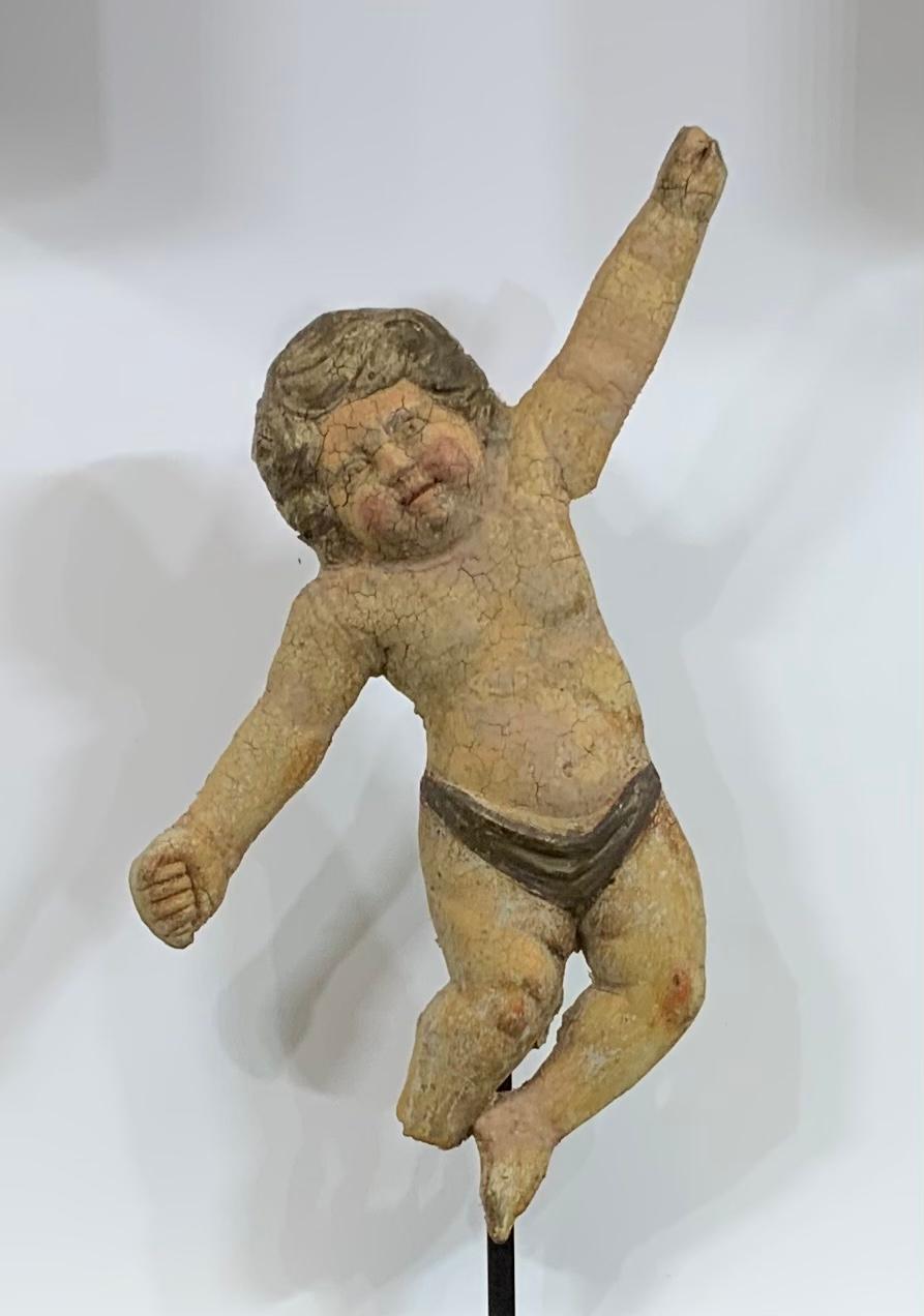 Exceptional antique terra cotta cherub beautifully sculpted by the artist and hand painted. This cherub was salvaged from estate wall in Italy and professionally restored so it is structurally strong to be display on steel custom-made base , or
